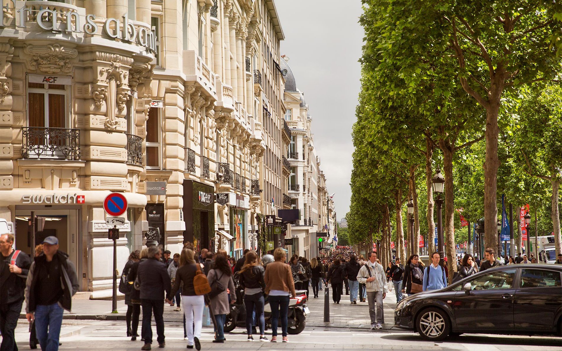 Bustling stroll along the Champs-Élysées, just steps from Hôtel San Régis, perfect for a shopping stay in Paris.
