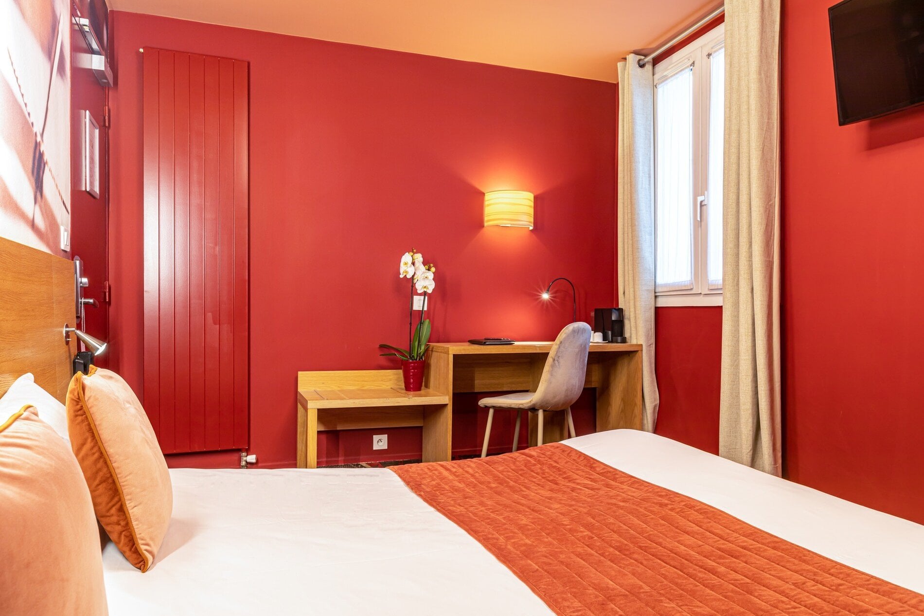 Espace de travail de la Chambre Supérieure Double avec bureau, télévision à écran plat et décoration élégante à l'Hôtel Ariane Montparnasse