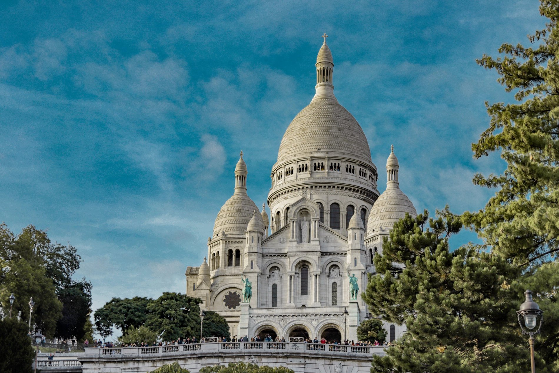 Basilica of the Sacré-Cœur in Montmartre under a blue sky in Paris near Maison Cassandre