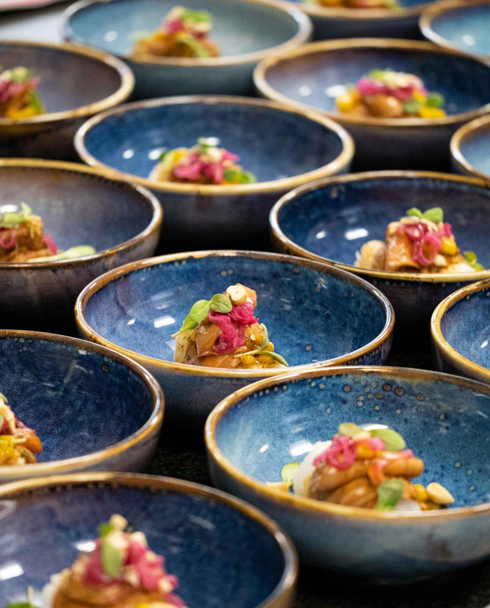 Tasting plates with colorful dishes arranged on a table.