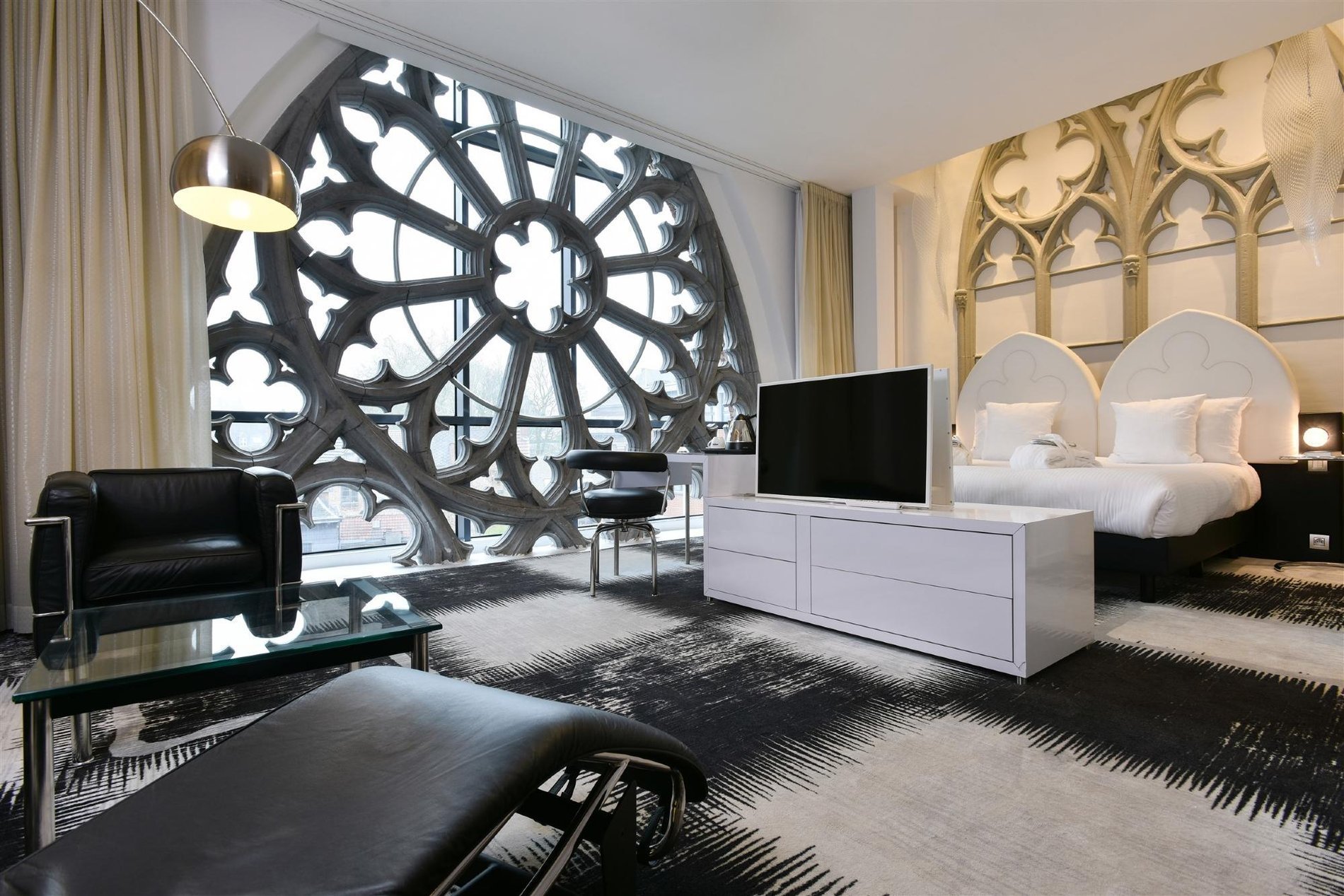 Best of Home Zimmer: Bett und Lounge mit Glasfenster.