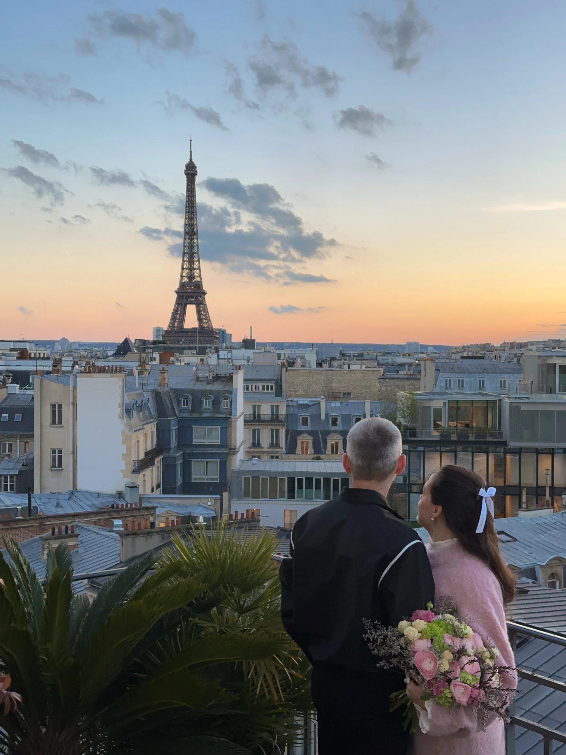 Couple admiring the Eiffel Tower from a terrace at sunset at Hôtel Marignan