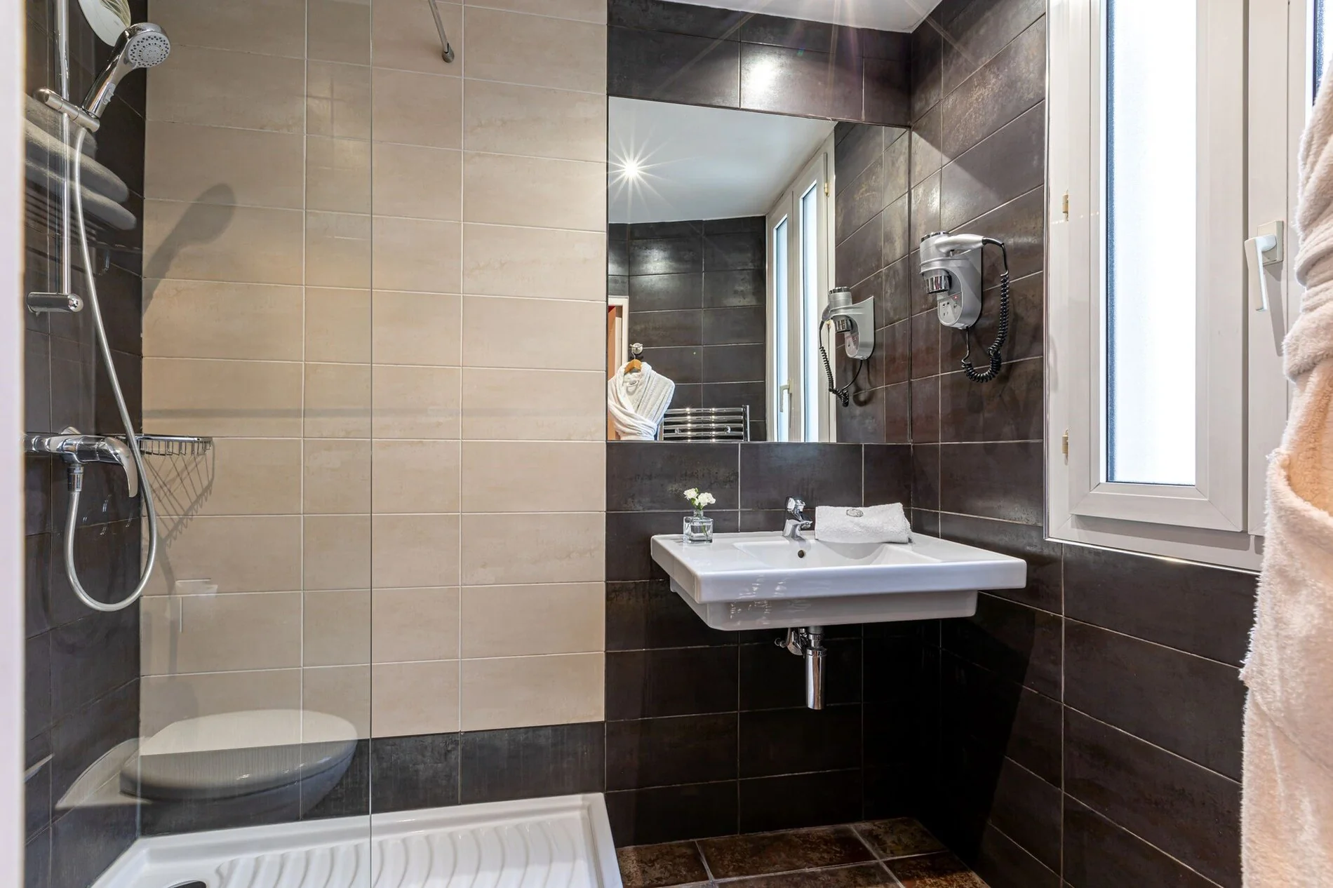 Salle de bain privative de la Chambre Confort Double avec douche à l'italienne, fenêtre et équipements modernes