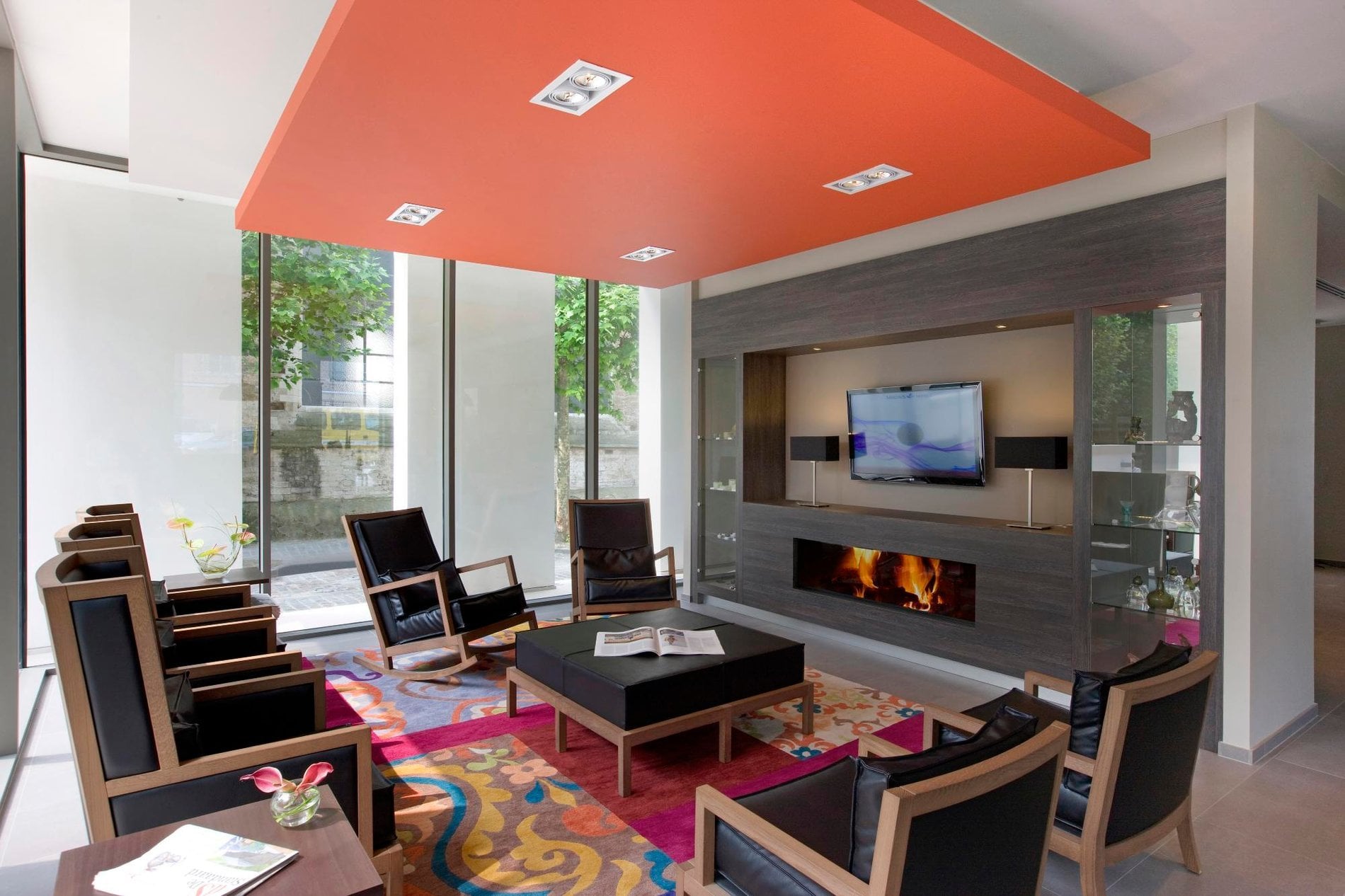 Contemporary lounge with a fireplace at Martin's Klooster in Leuven.