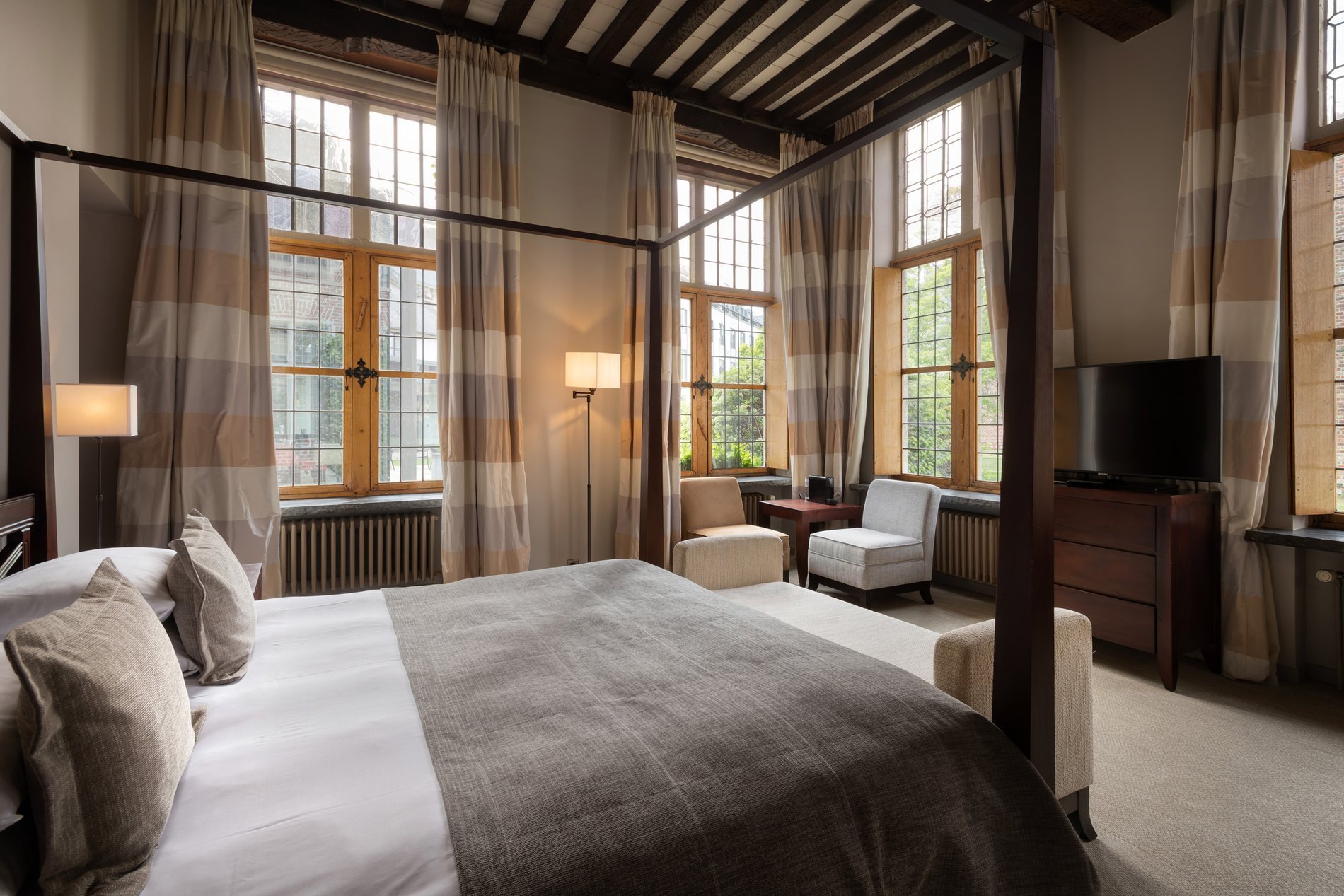 Chambre lumineuse avec des détails rouges au Martin's Klooster à Louvain.