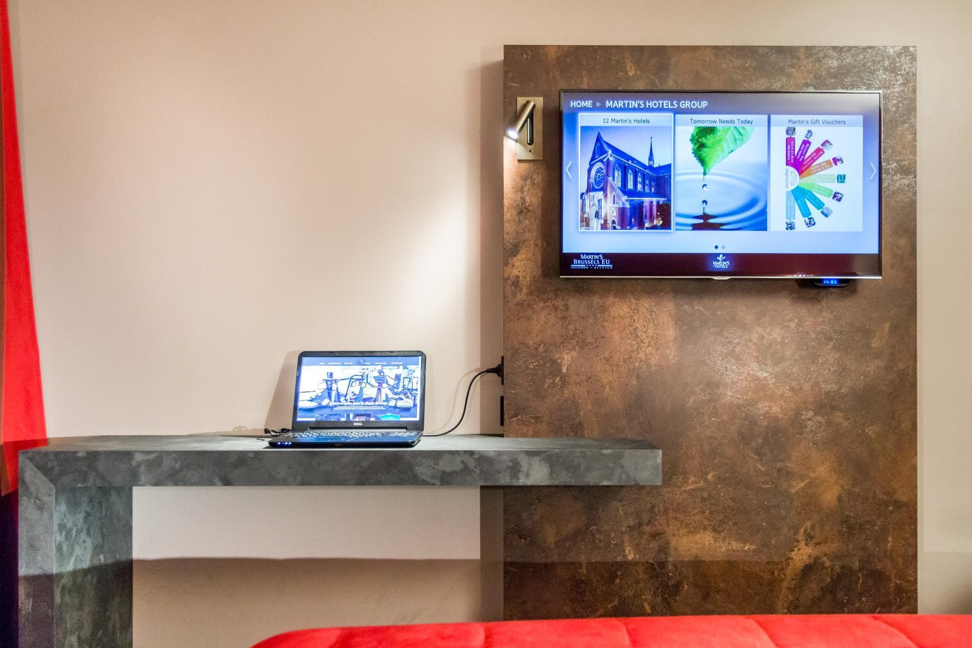 Desk corner in the room with a wall-mounted TV