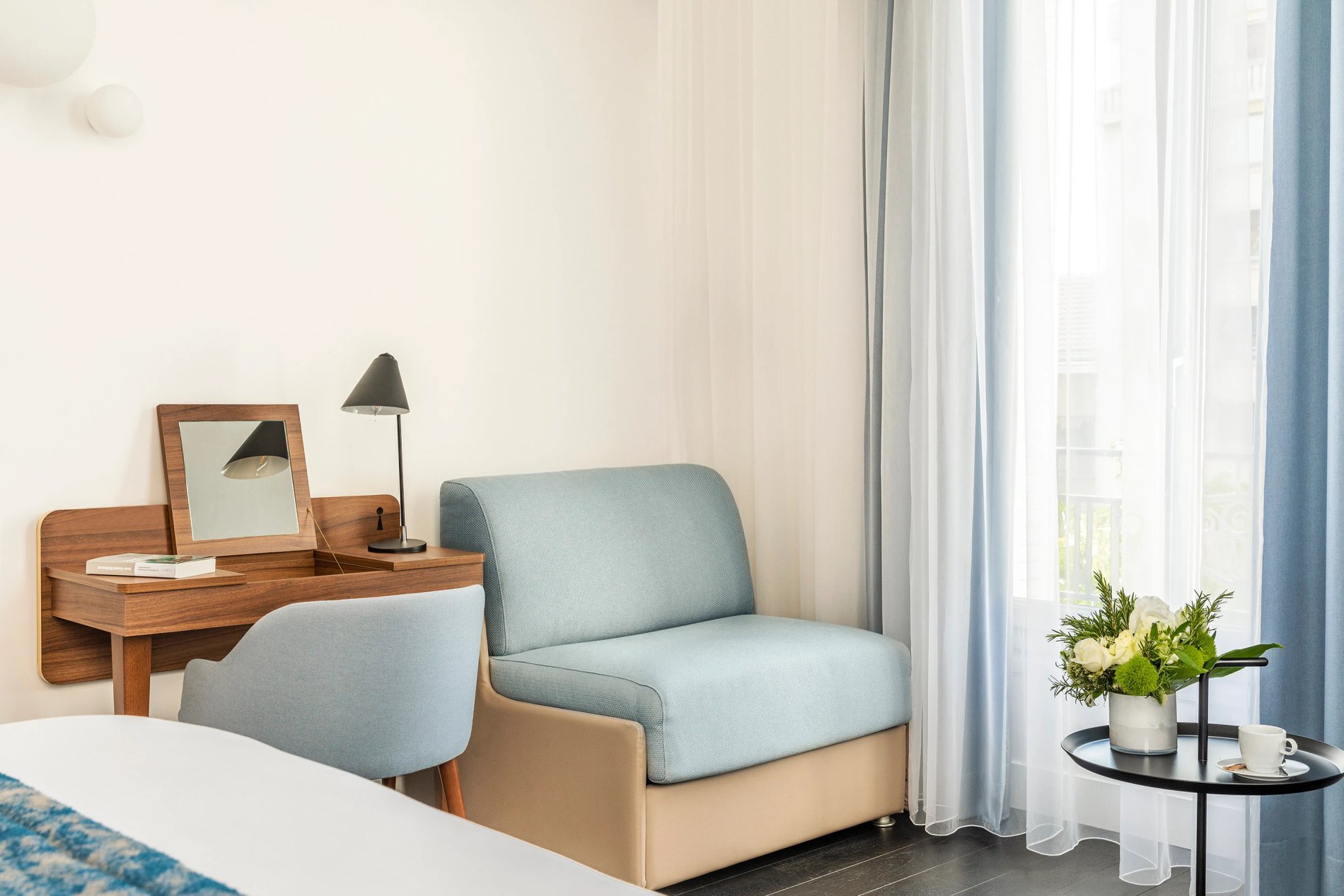 Chambre supérieure avec bureau et fauteuil, symbolisant le confort et l'espace de travail de BW La Demeure Paris.