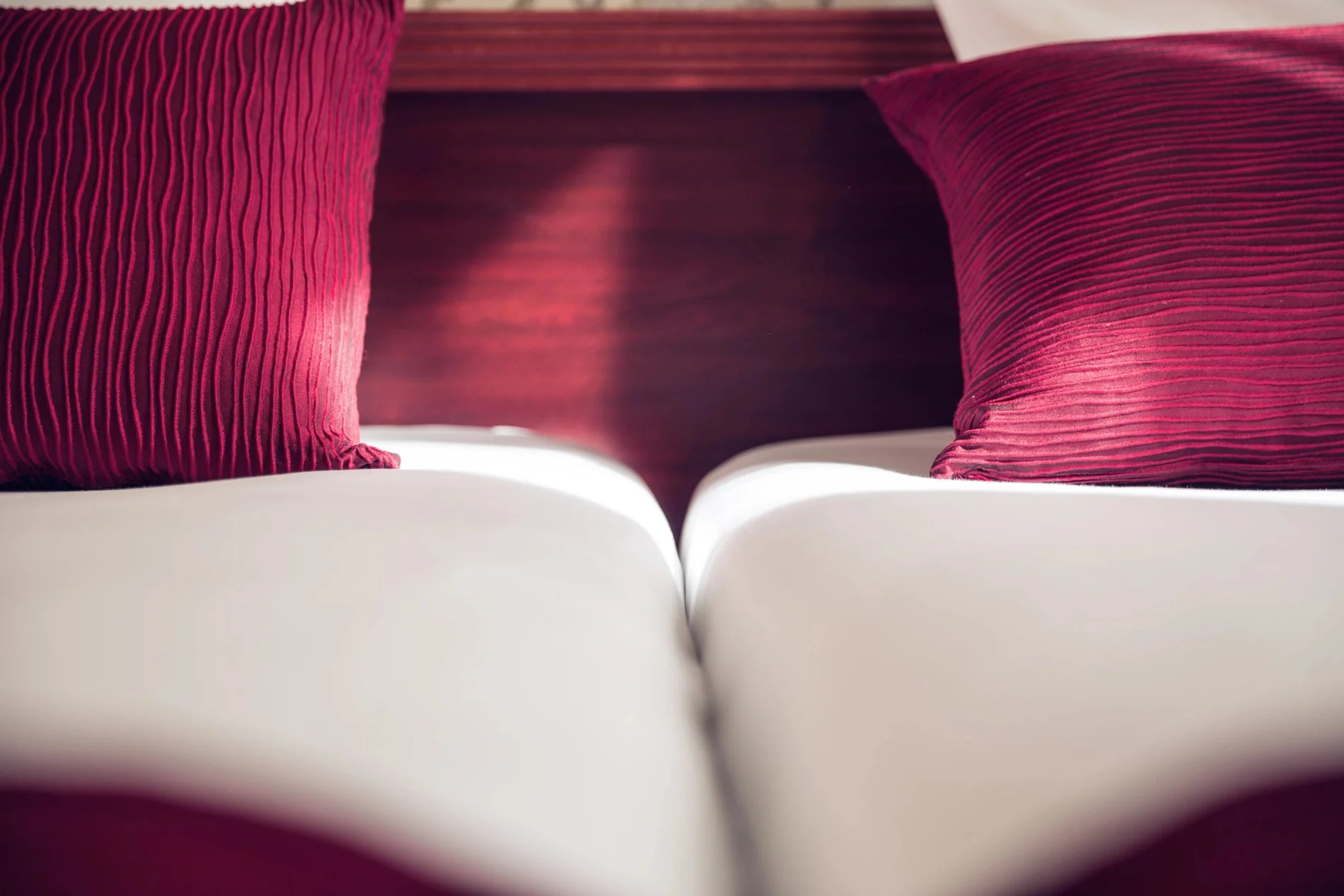 Détail de décoration dans une chambre au Timhotel, coussins rouges