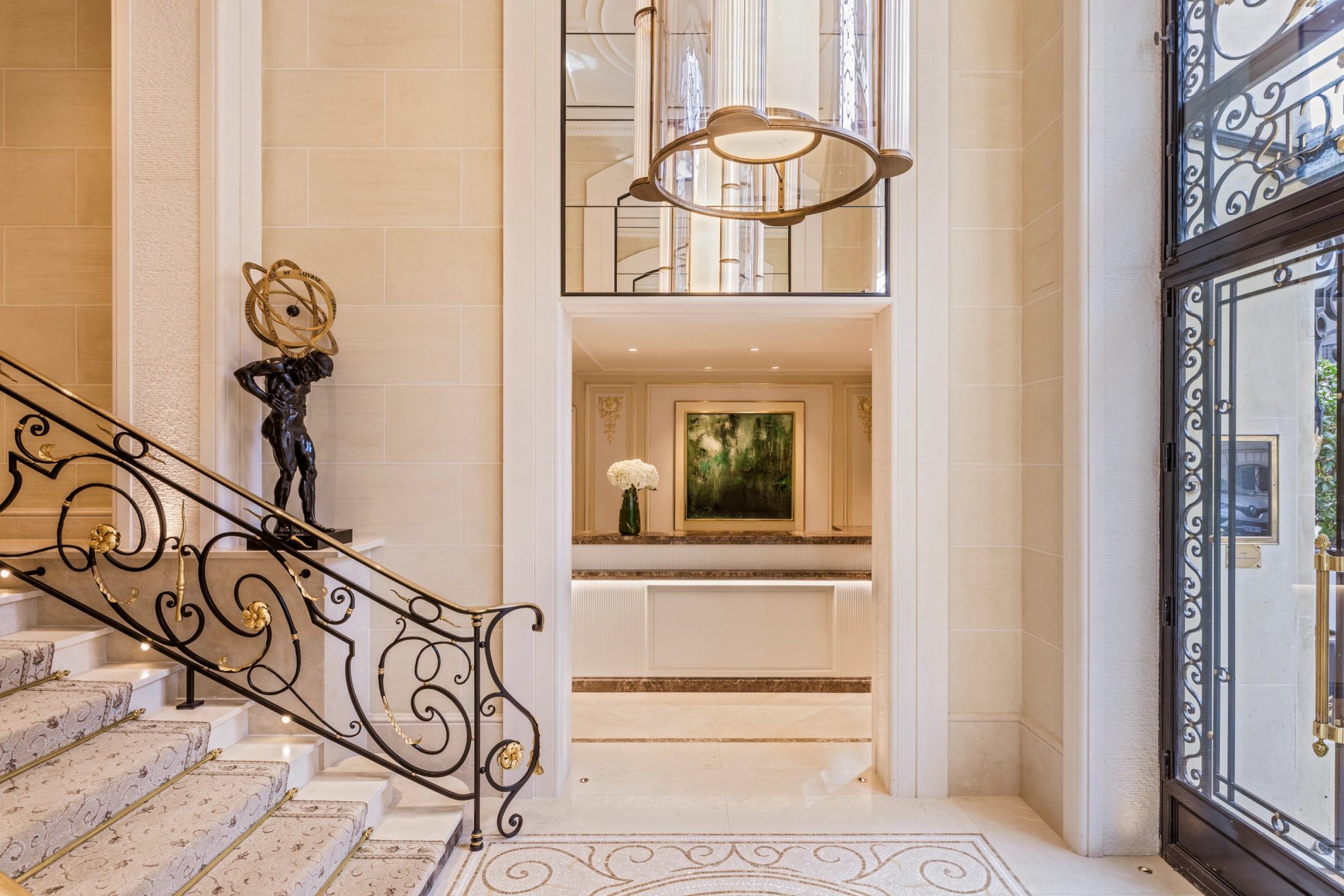 Luxurious entrance with spiral staircase and decorative sculpture