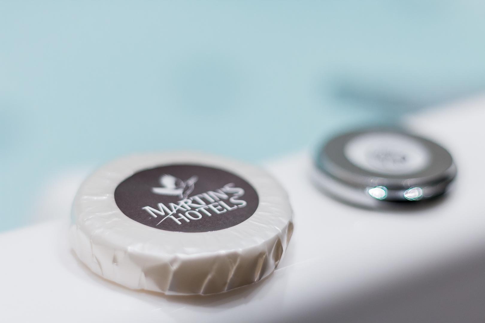 Martin's Hotels bath product on the bathtub edge