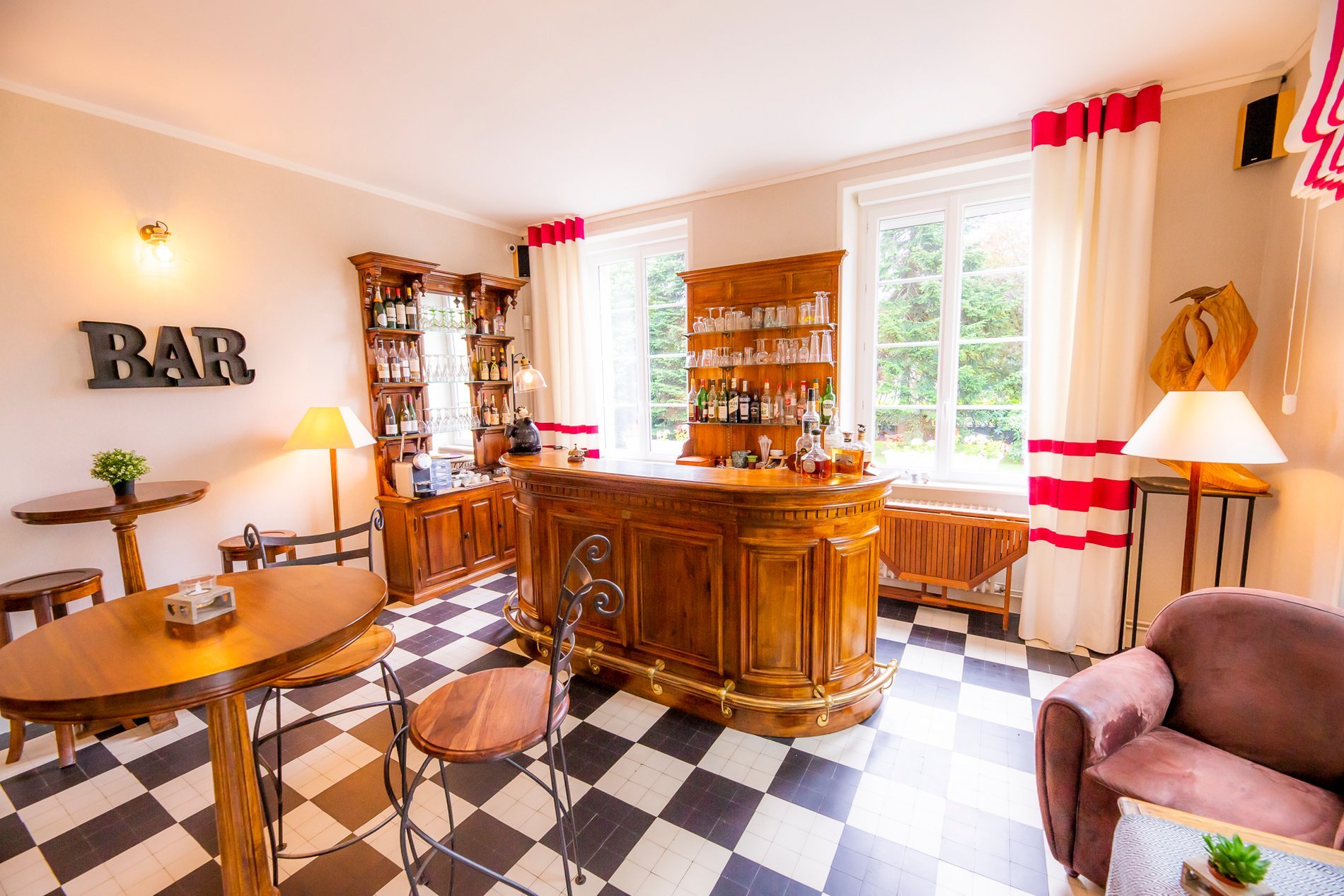 Bright interior of Hotel La Ramade's bar in Avranches, symbolizing a welcoming and open space.