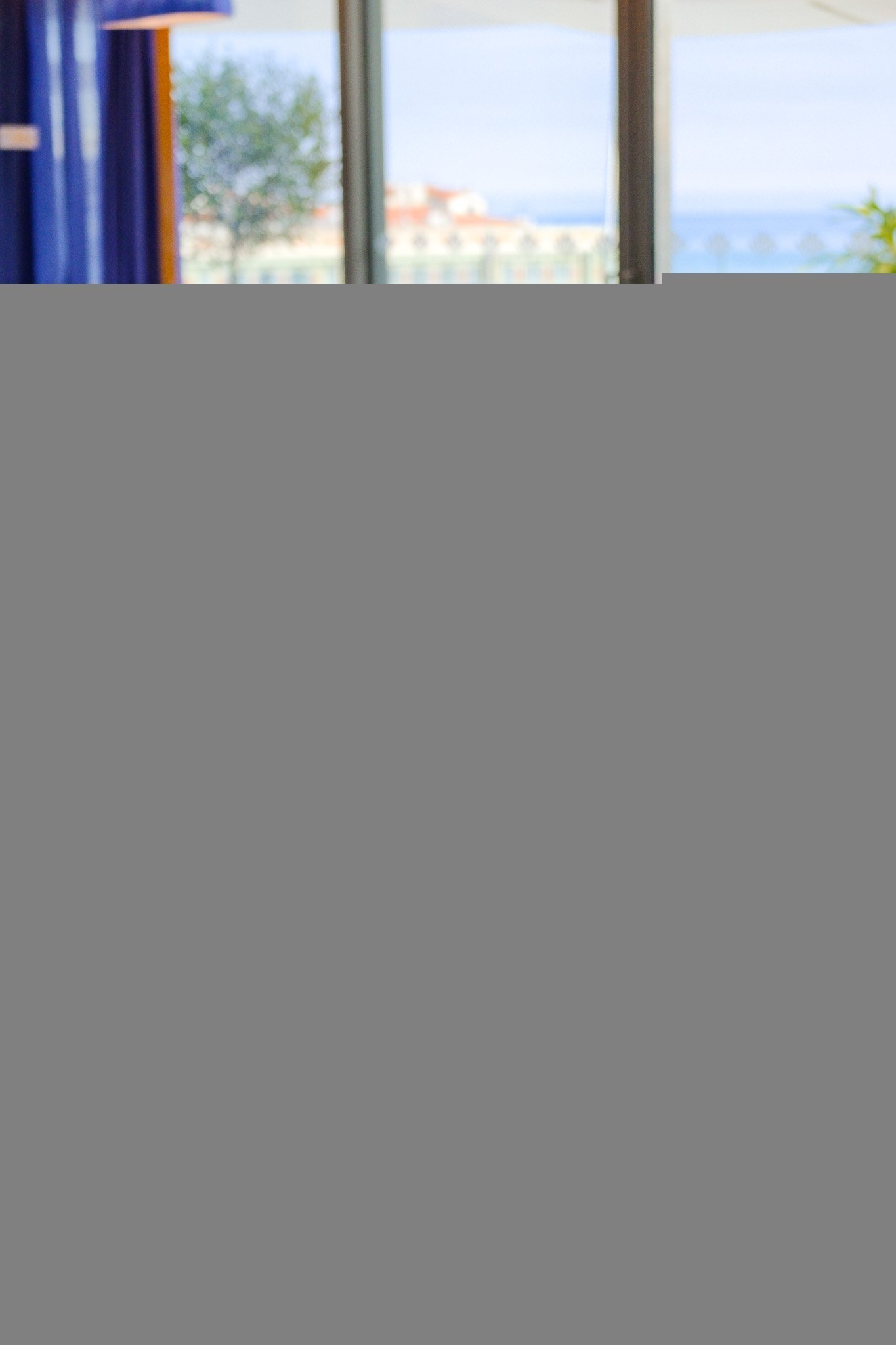 Royal blue restaurant: set tables and comfortable armchairs at Taulissa Bar.