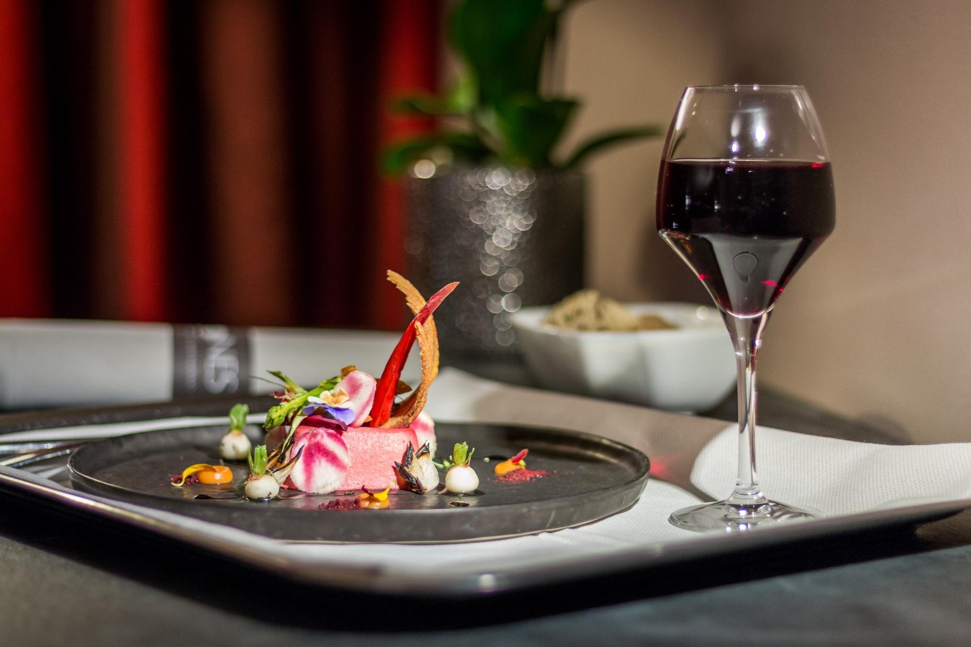 Gourmet dish served with a glass of red wine