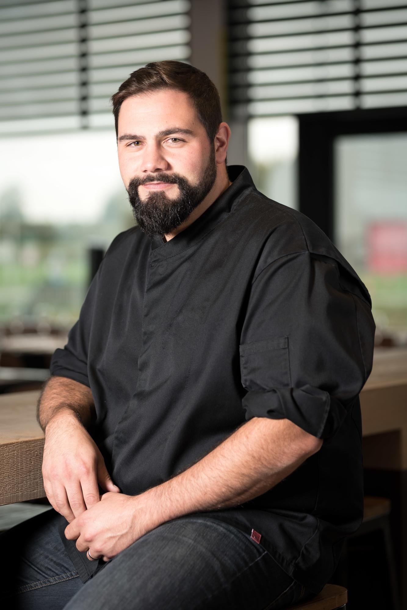 Portrait of chef Ludovic Tabourdon in a chef's uniform inside the restaurant.