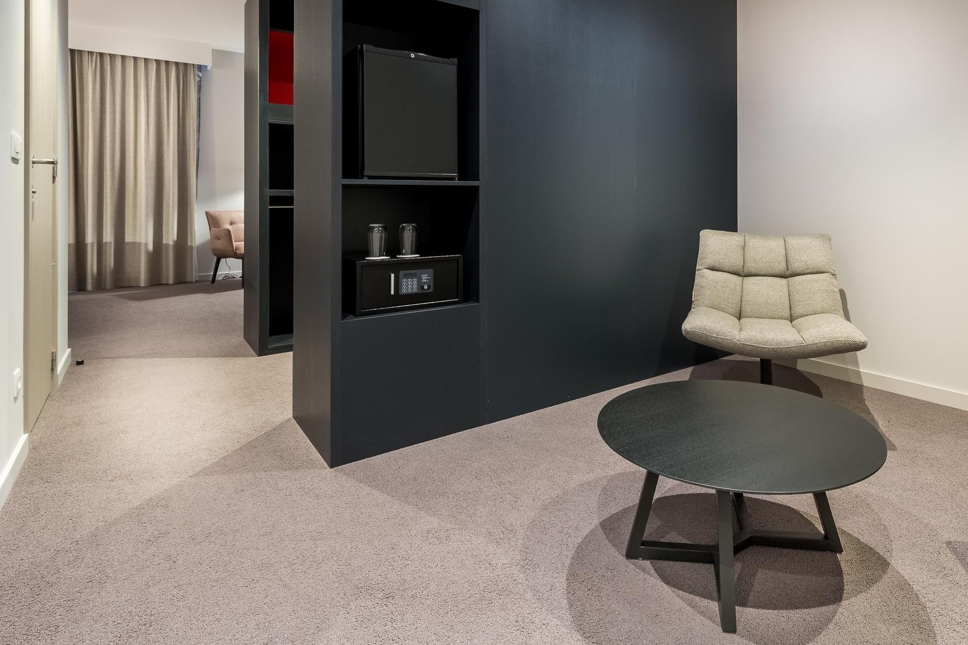 Seating area in a room at Martin's Red with a coffee table, chairs, and wall-mounted TV.