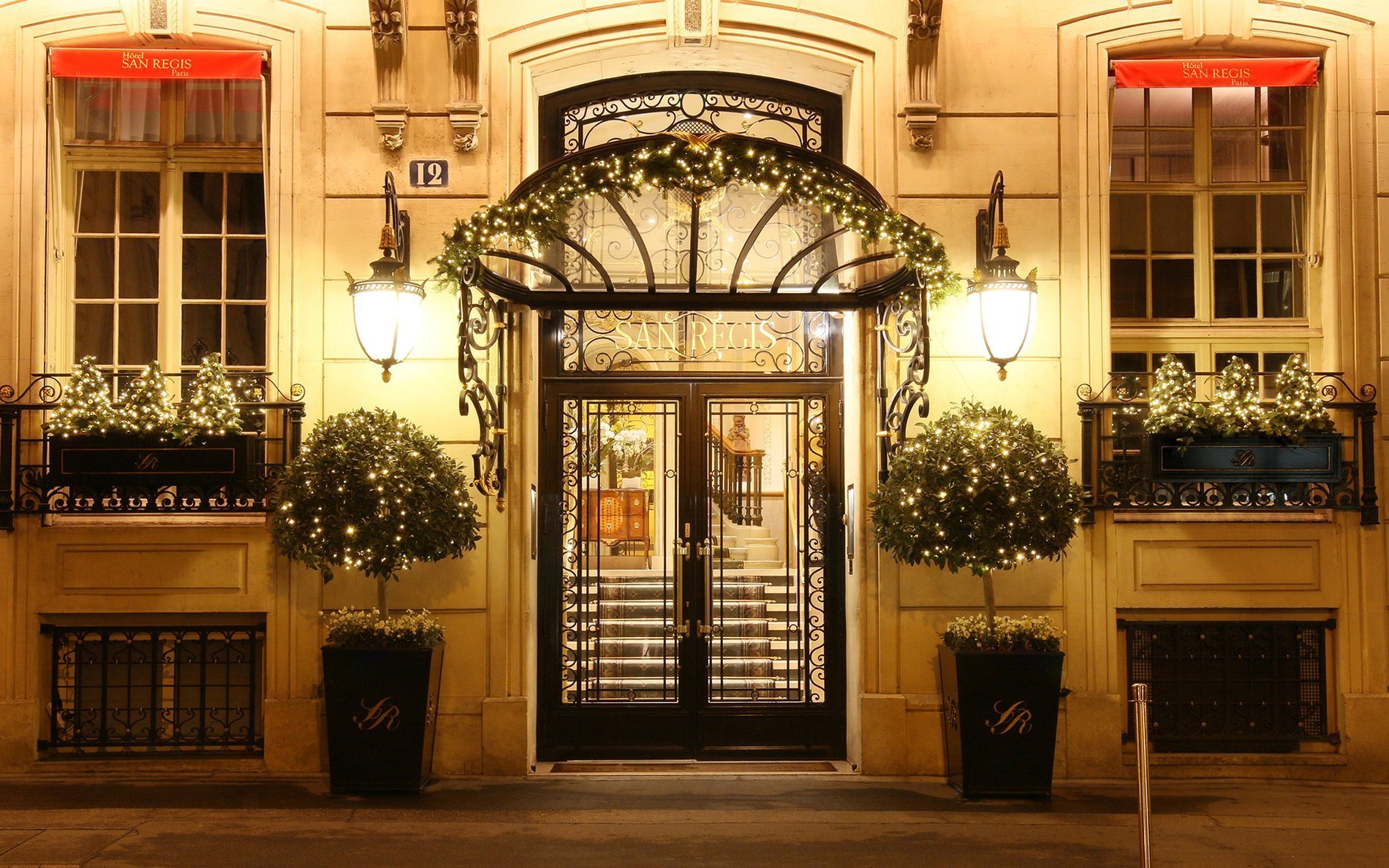 Hôtel San Régis front entrance beautifully decorated with festive lights and garlands, in the heart of Paris 8.