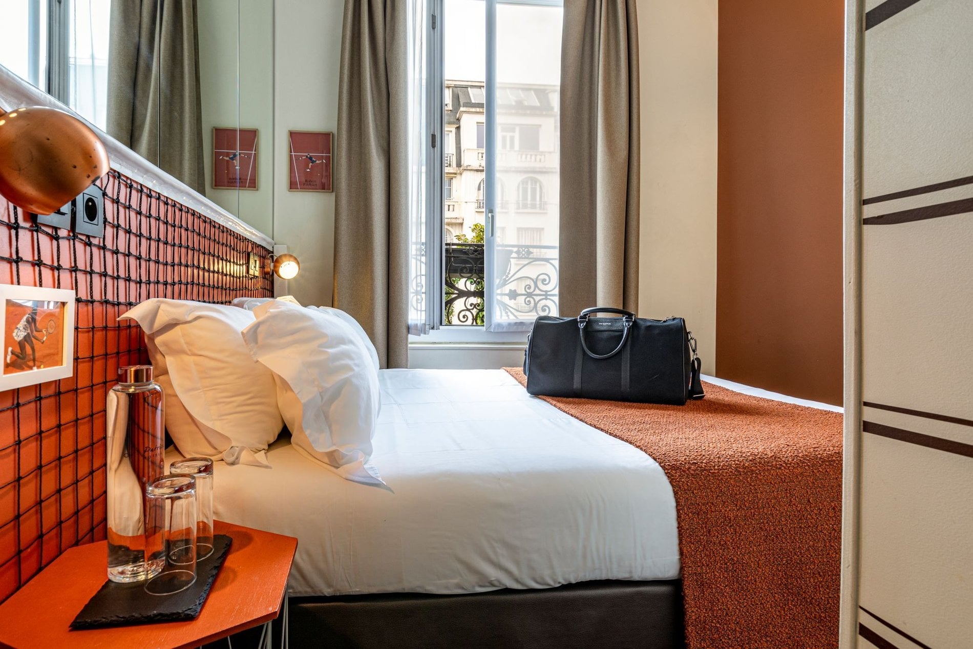 Chambre Classique Double Olympic à Boulogne-Billancourt avec lit double, vue sur la ville, décoration sur le thème du tennis et confort moderne.