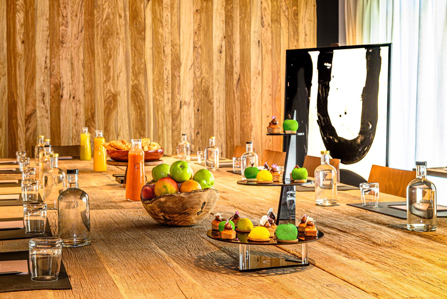 Seminar table set with fruits, treats and branded water bottles
