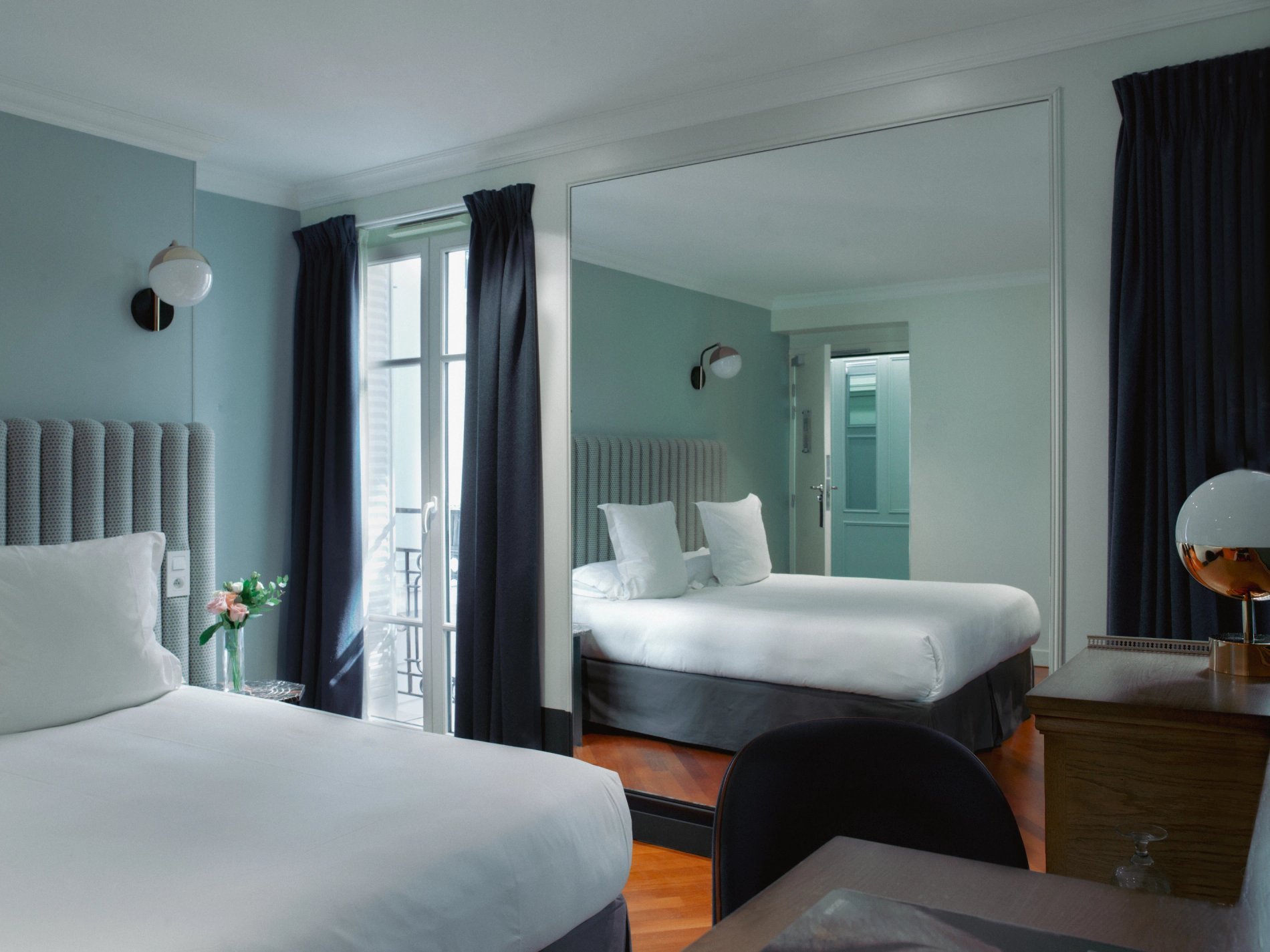 Bright, design room with mirror and balcony at Hôtel Bachaumont