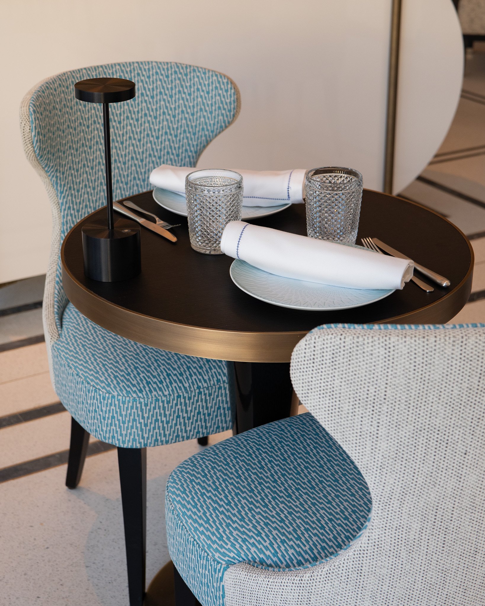Café Le Victoria | Table for two and comfortable blue armchair