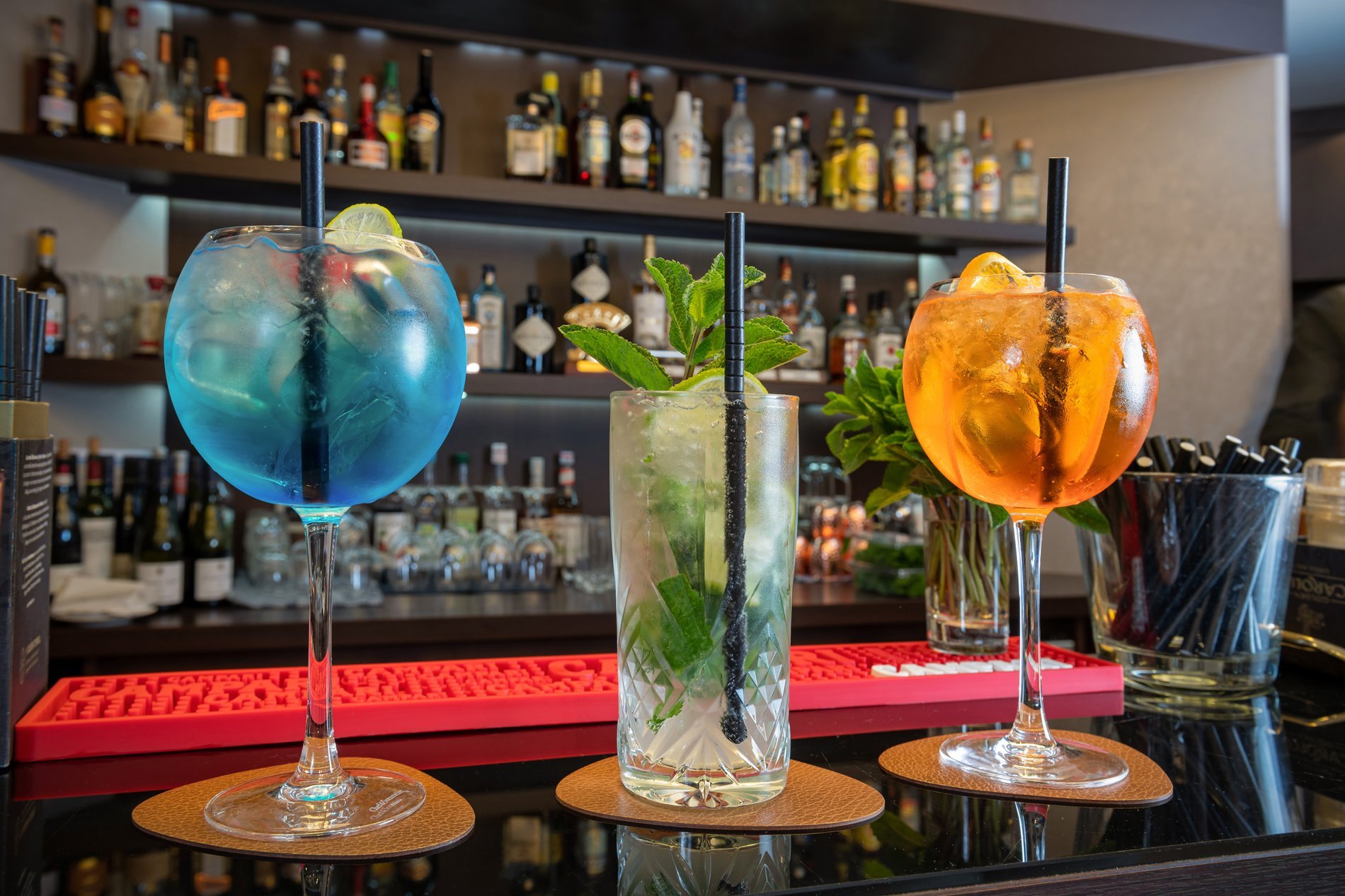 Kleurrijke cocktails geserveerd aan de bar van Martin's Patershof, een uniek hotel in Mechelen.