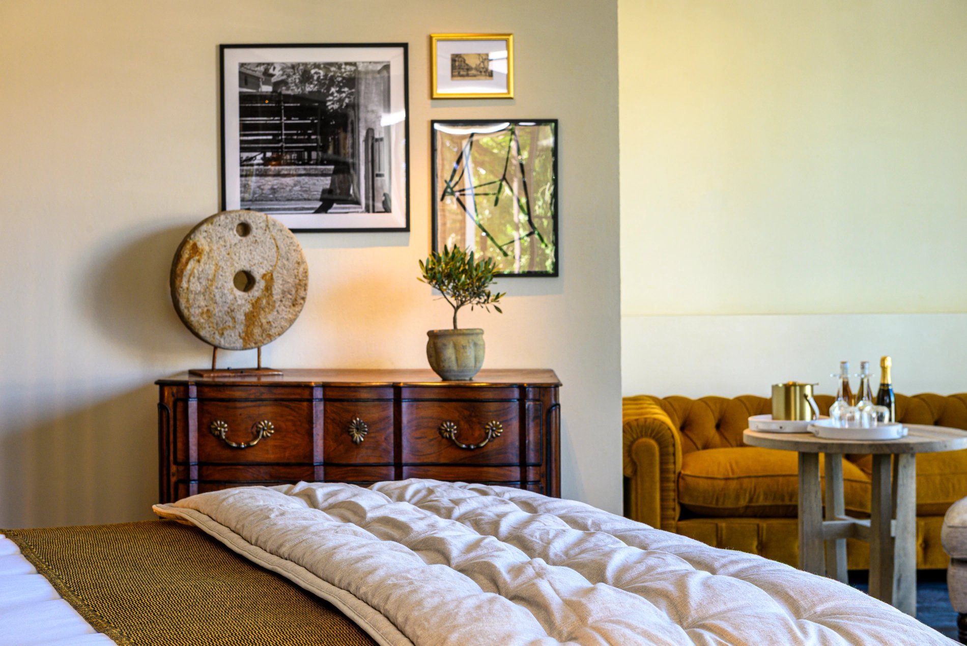 Chambre élégante avec commode ancienne, déco murale et coin salon à L’Isle de Leos.