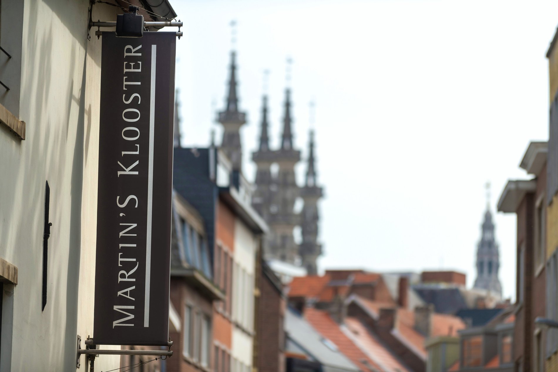 Facade of Martin's Klooster hotel with a view of Leuven's historic center.