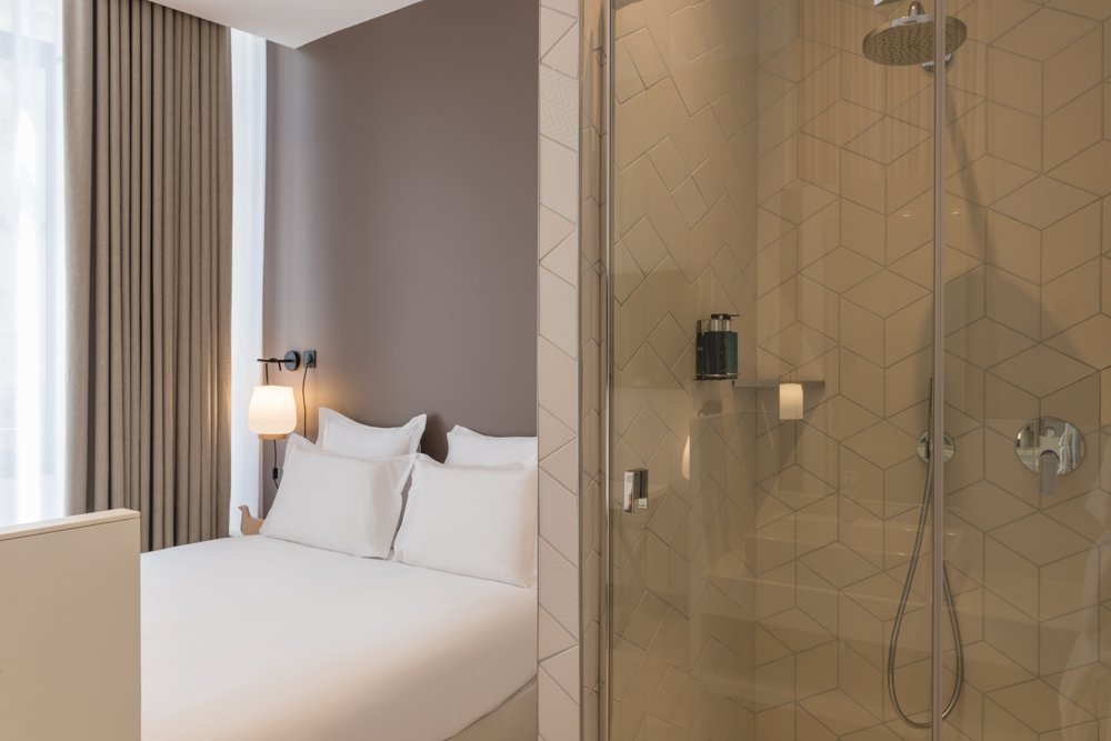 A bright, spacious 25m² Masterpiece room with an open-plan shower area and separate toilet.