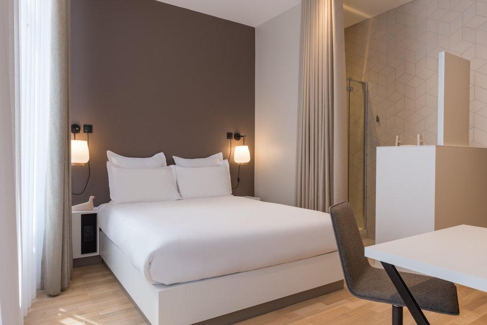 A bright, spacious 25m² Masterpiece room with an open-plan shower area and separate toilet.