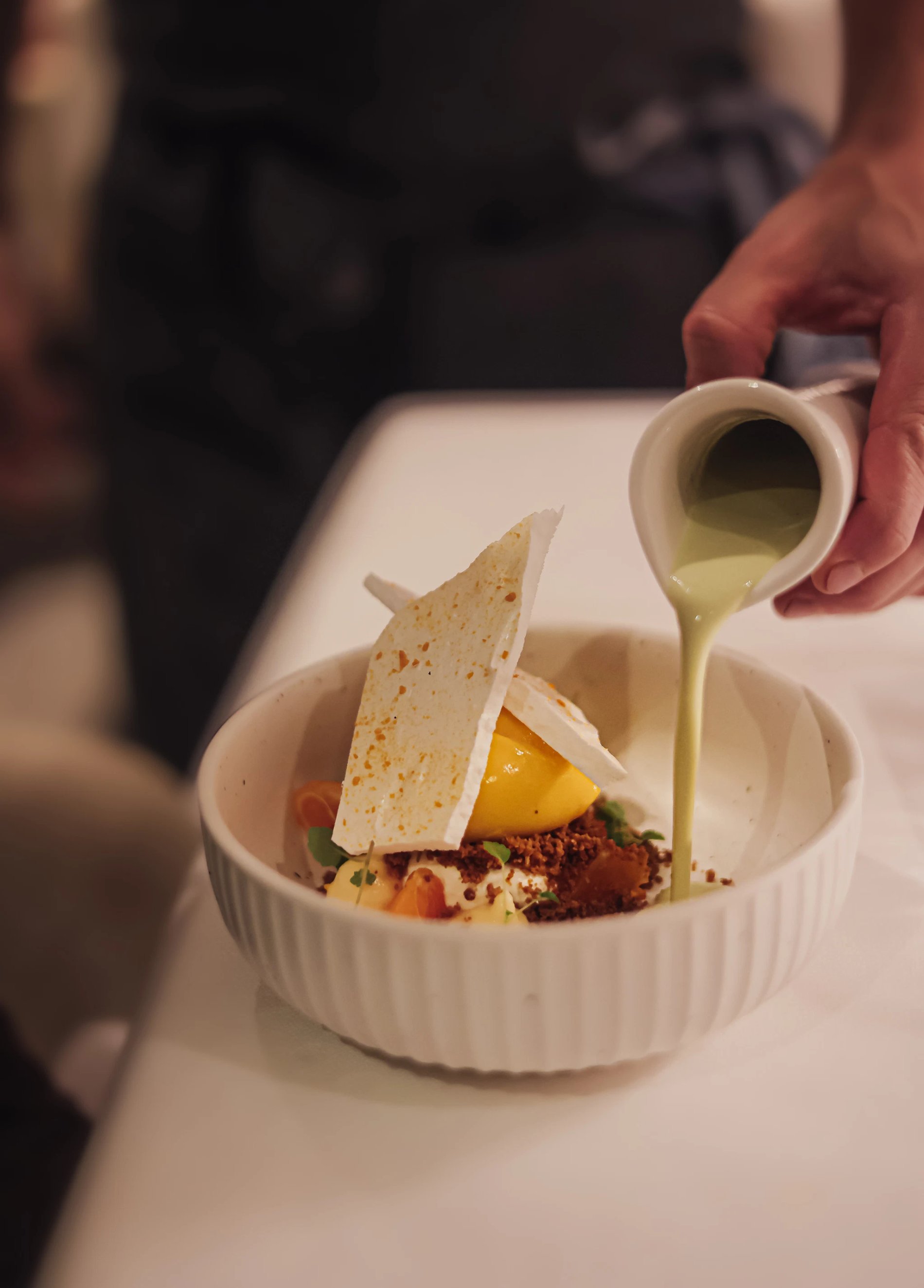 Gastronomisch dessert met saus gegoten in restaurant Akko van Martin's Rentmeesterij.