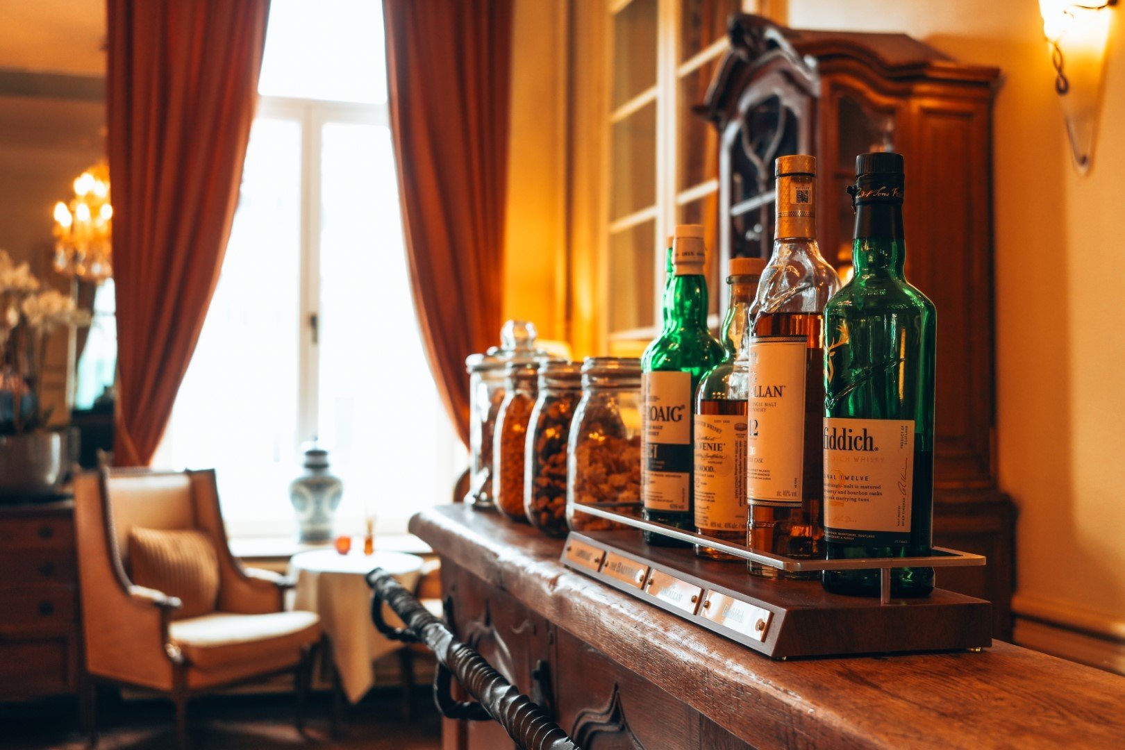 Elegant room with bottles on a cabinet at Martin’s Relais Hotel.