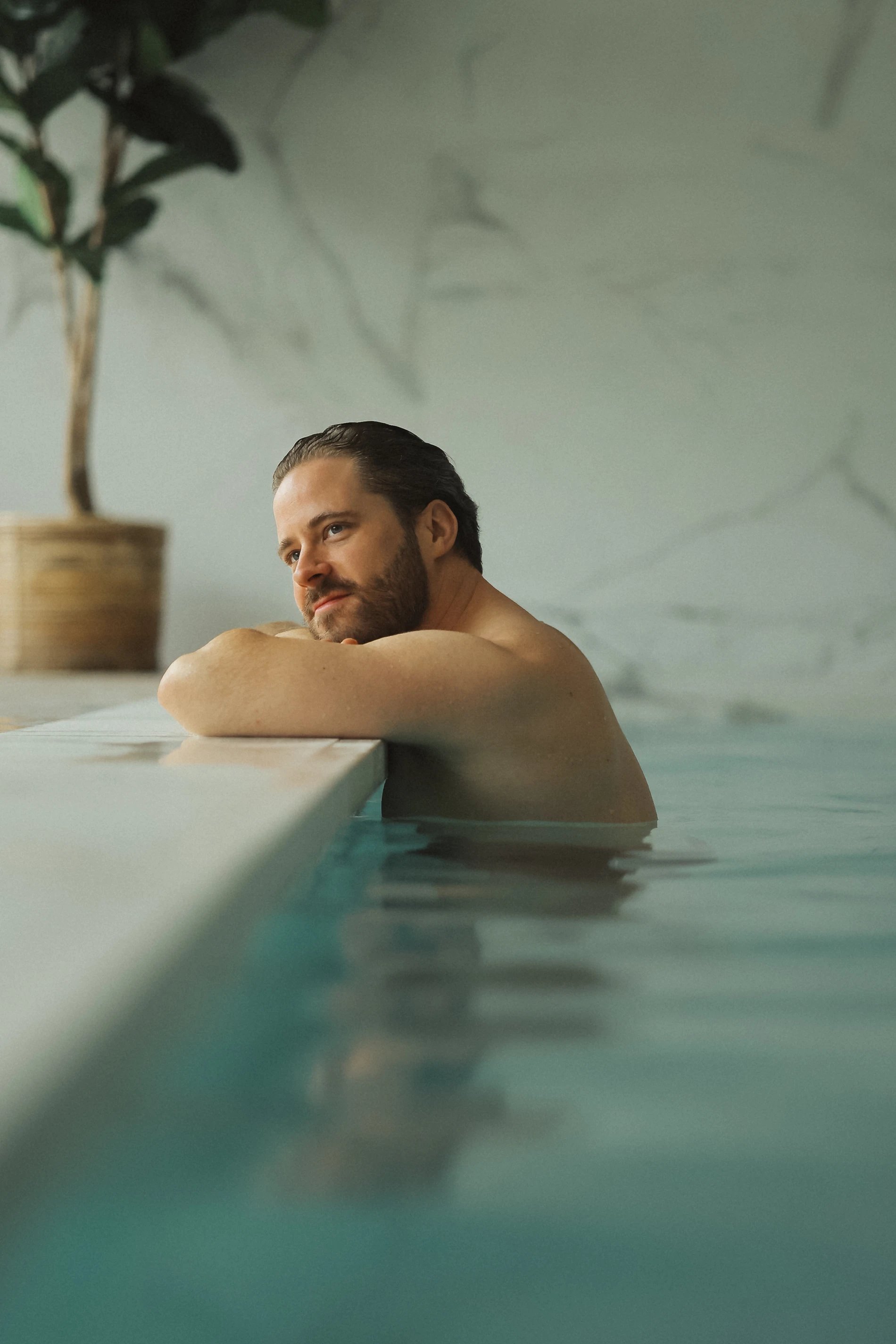 Man relaxing in a heated pool at a spa in Belgium