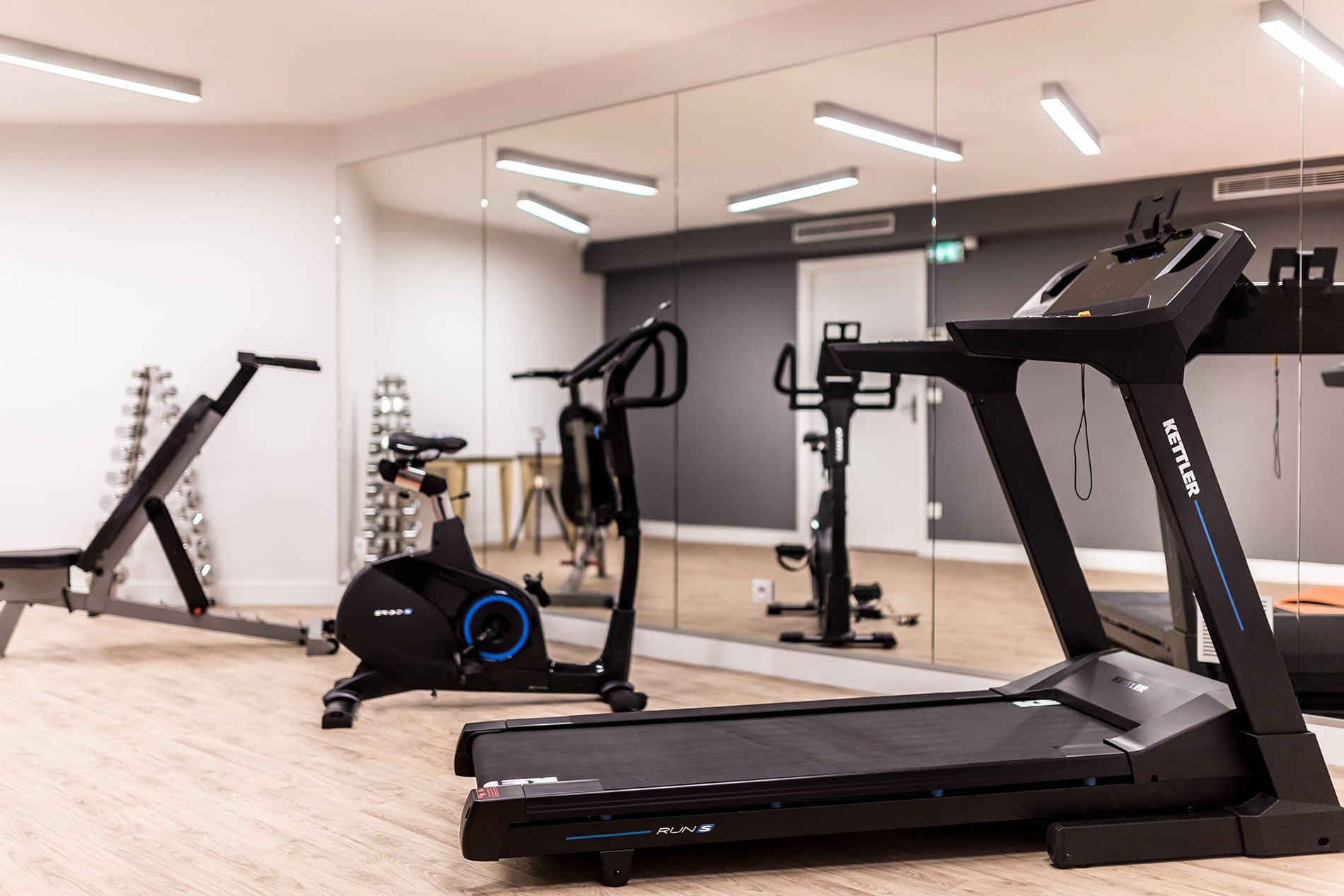 Modern and well-equipped gym at the Marais Grands Boulevards Hotel in Paris, available for guests.