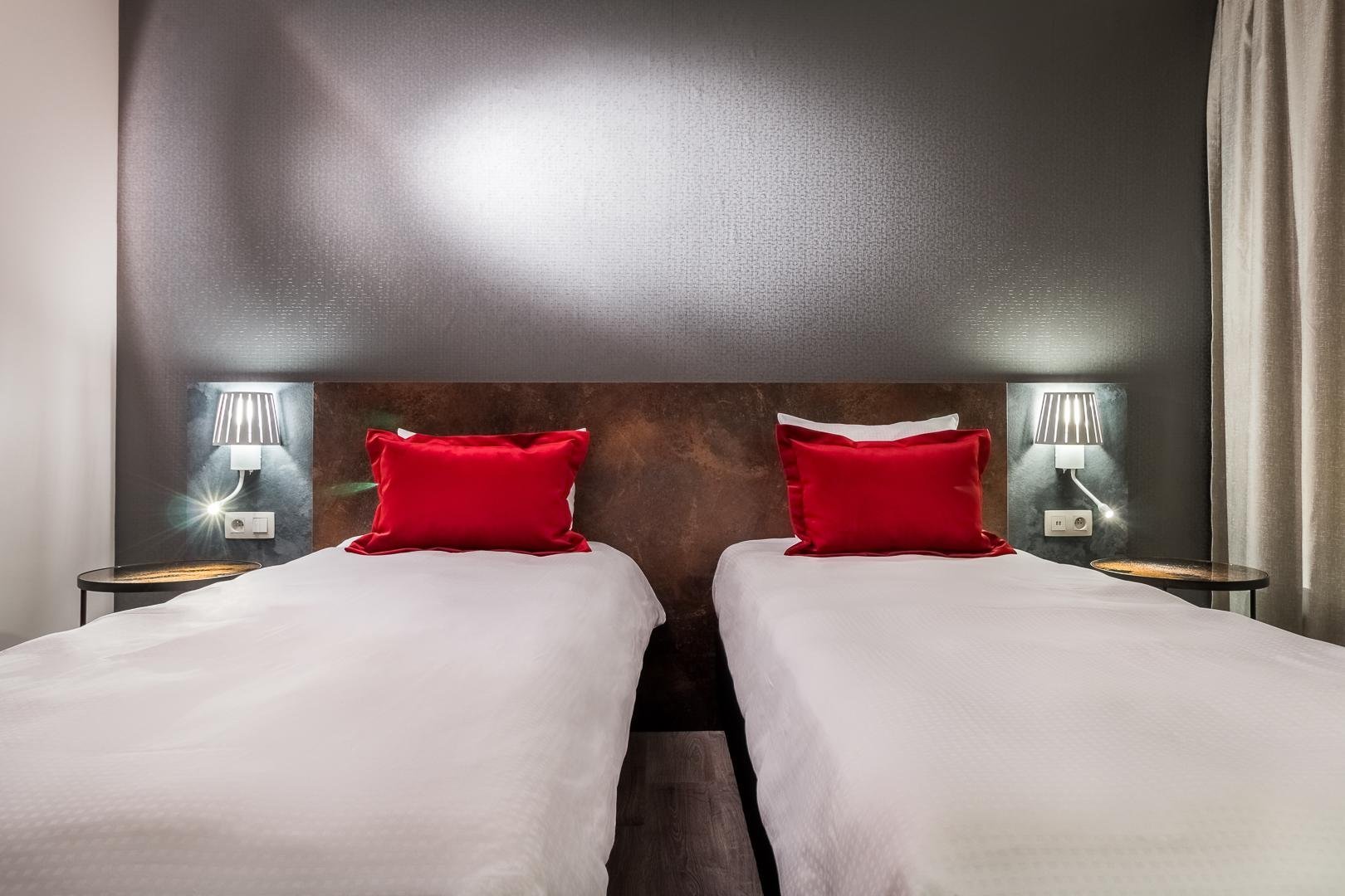 Two single beds with a modern and elegant headboard