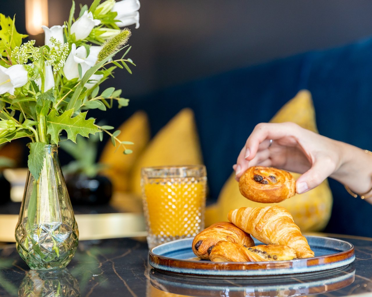 Appetizing breakfast at the restaurant of VOCO Paris Montparnasse with pastries, orange juice, and coffee.