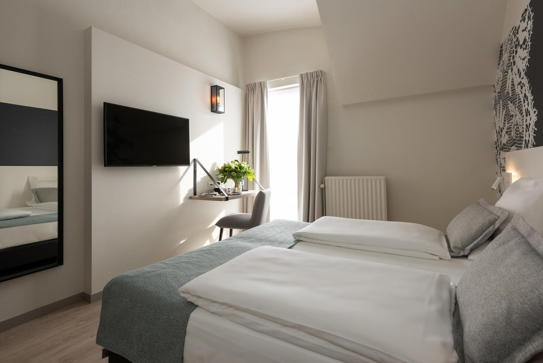 Fernseher und Sitzbereich in einem zeitgemäßen Zimmer im Martin's Brugge