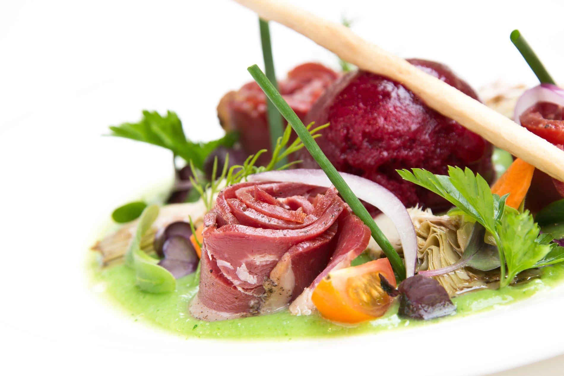 Le Jardin du Cloître of Hotel Le Couvent des Minimes in Lille features a gourmet dish, beautifully plated and bursting with colors and flavors.