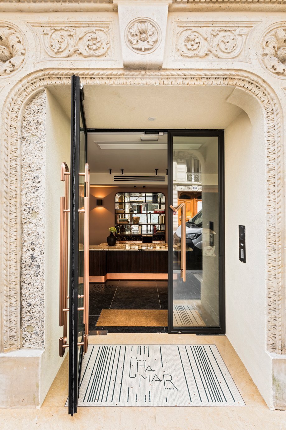 Detail of the ornate entrance of Hotel Chamar, typical Parisian architecture.