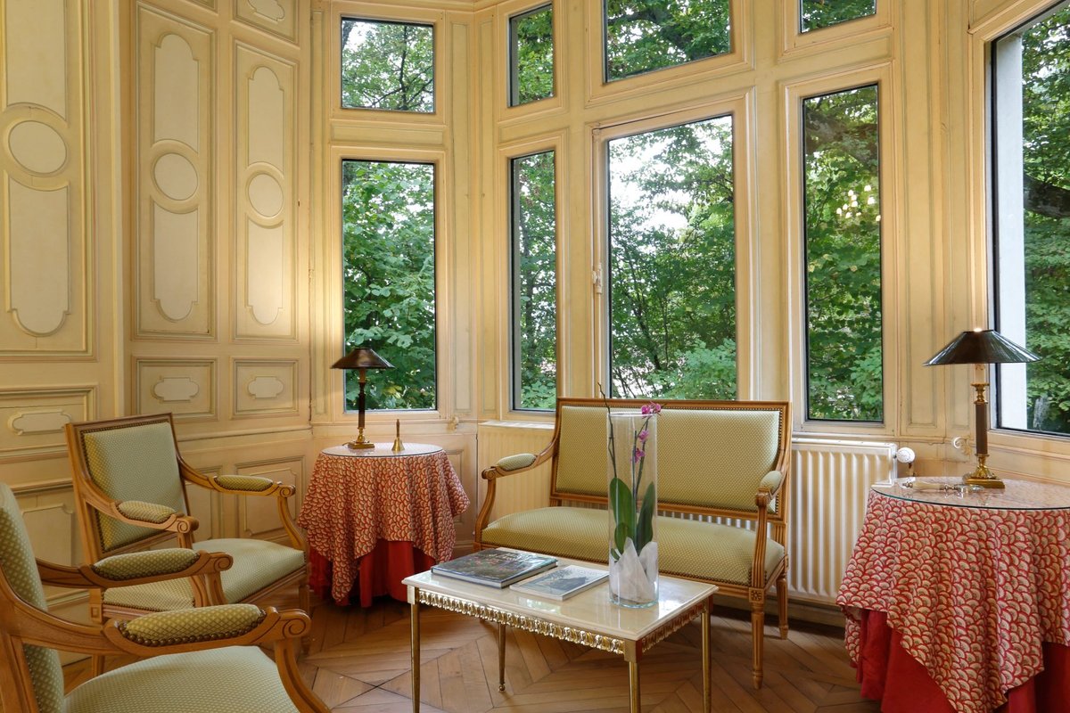 Château de la Rozelle, Salon élégant avec des meubles classiques et des fenêtres donnant sur la verdure à La Rochelle