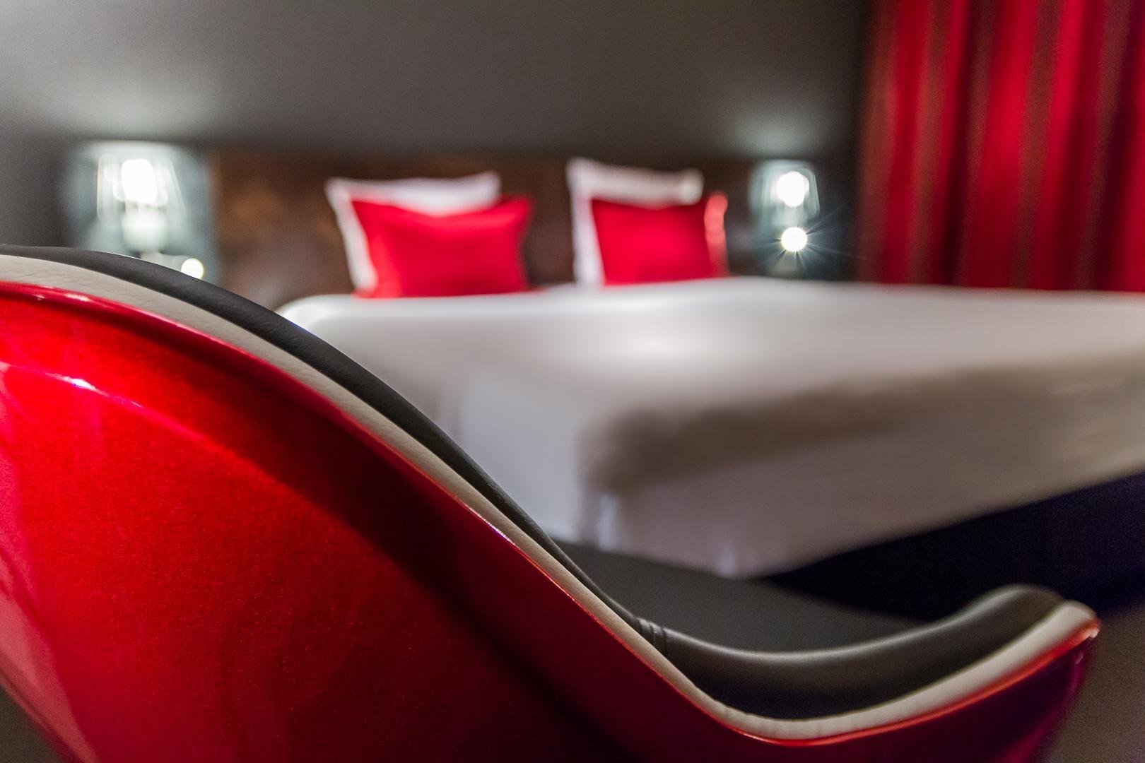 Designer chair and comfortable bed in the room