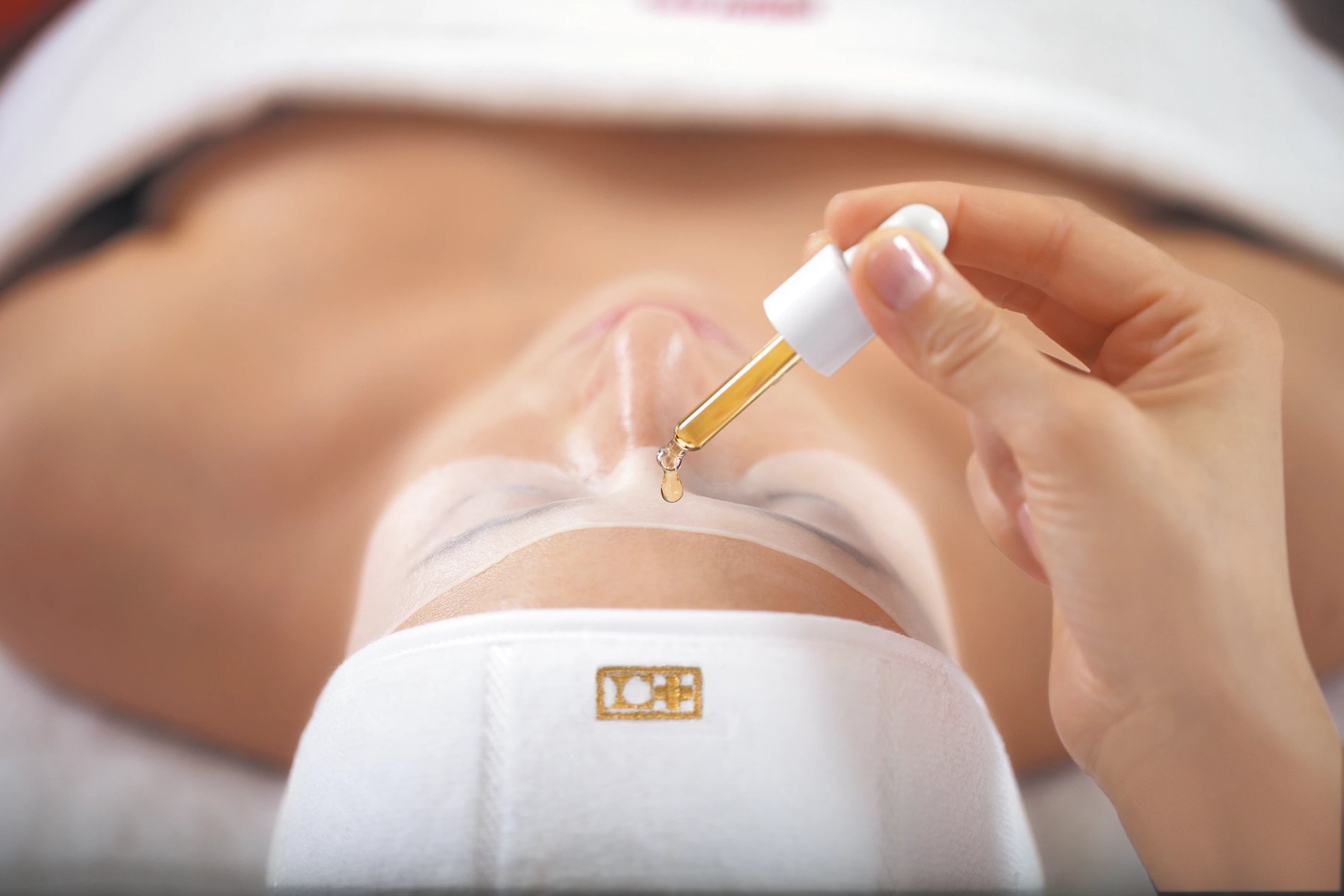 Facial treatment with serum applied by dropper at Spa Villa Belle Plage.