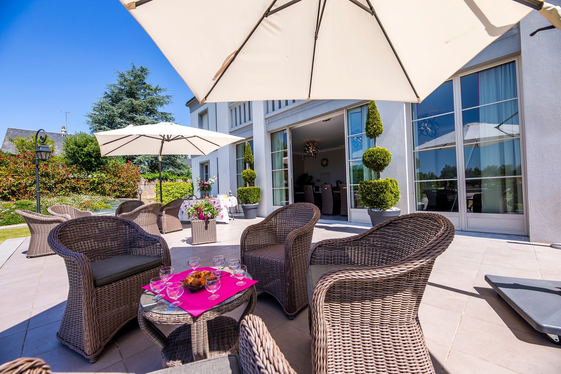 Hotel La Ramade's terrace with pathway and greenery, symbolizing neat and welcoming landscaping.