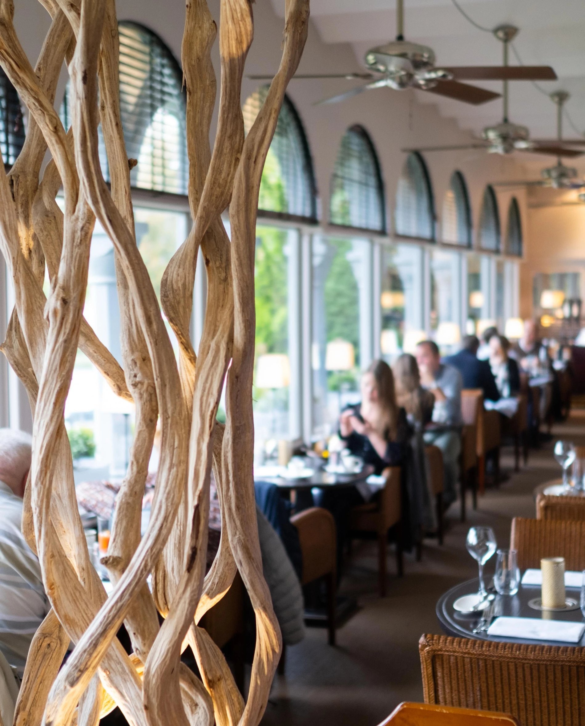 Bright restaurant with large windows and natural wood decor.