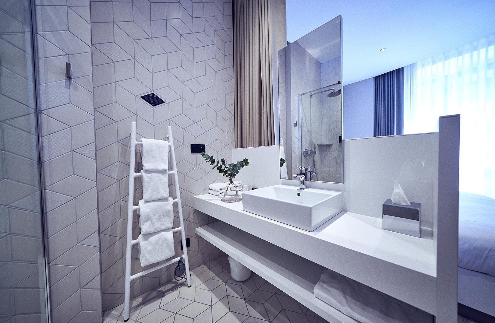 A bright, spacious 25m² Masterpiece room with an open-plan shower area and separate toilet.