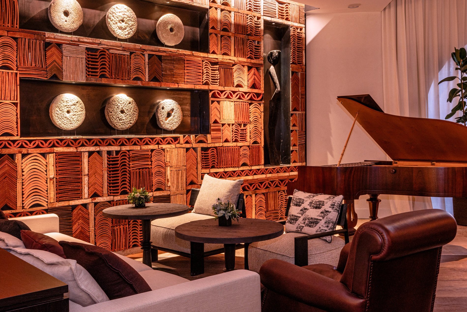 Salon élégant du Bar Nego Chin, avec fauteuils confortables et piano à queue.