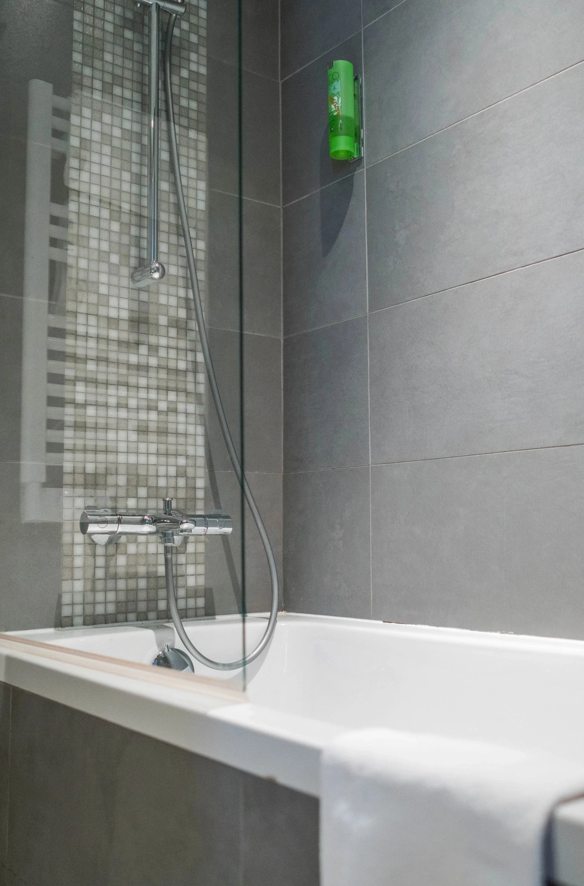 Salle de bain au Timhotel, avec douche et baignoire