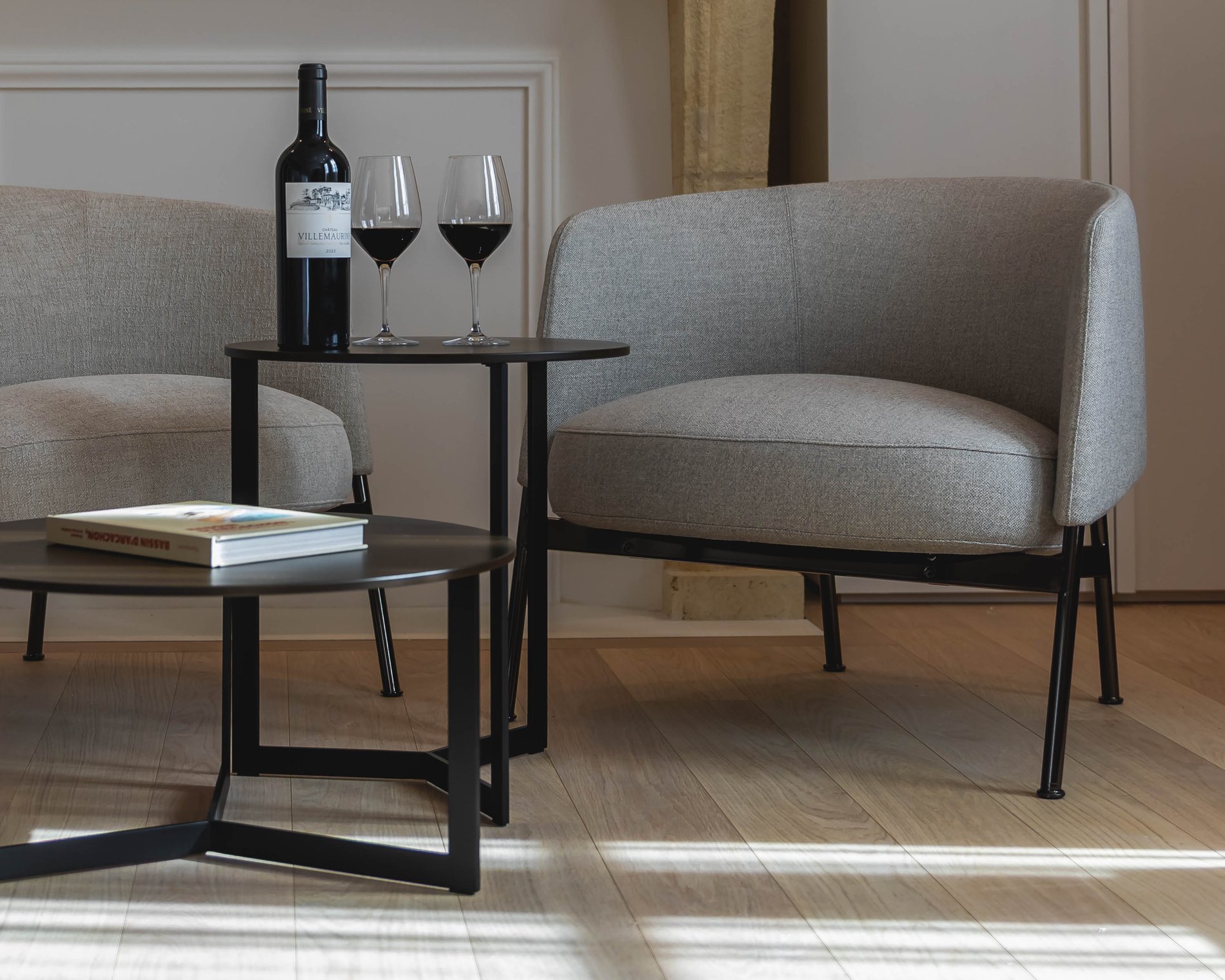 Coin salon avec fauteuils et table basse dans la Suite Signature de la Villa des Vignes