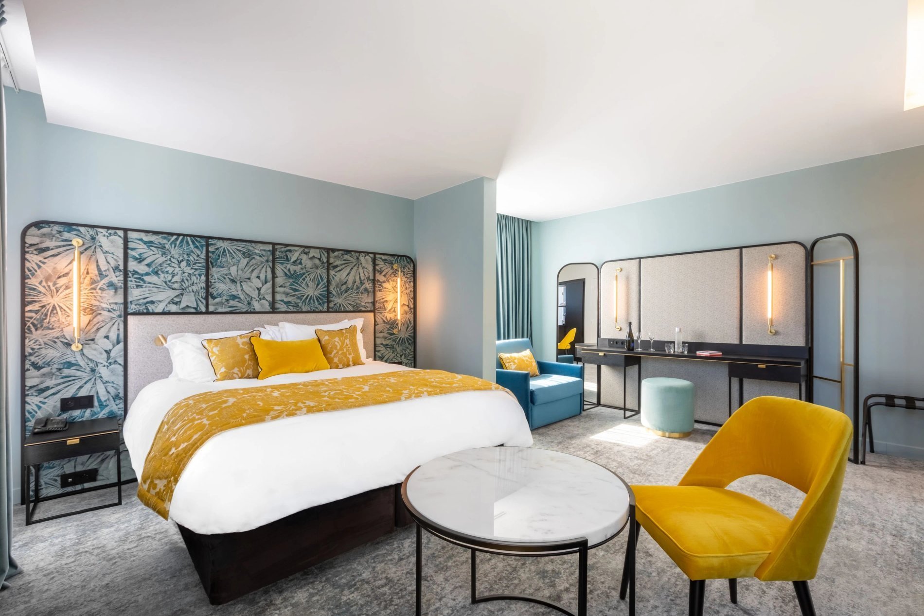 Spacious Premium Room at VOCO Paris Montparnasse with a double bed, a sofa bed, and yellow accents.