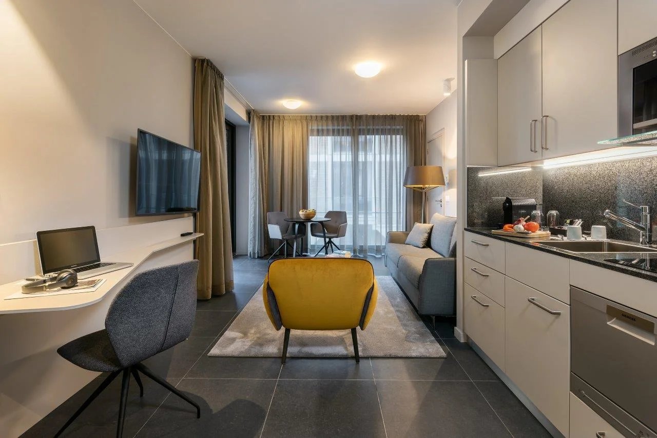 Modern suite with equipped kitchen and spacious living area at Martin's Hotels.