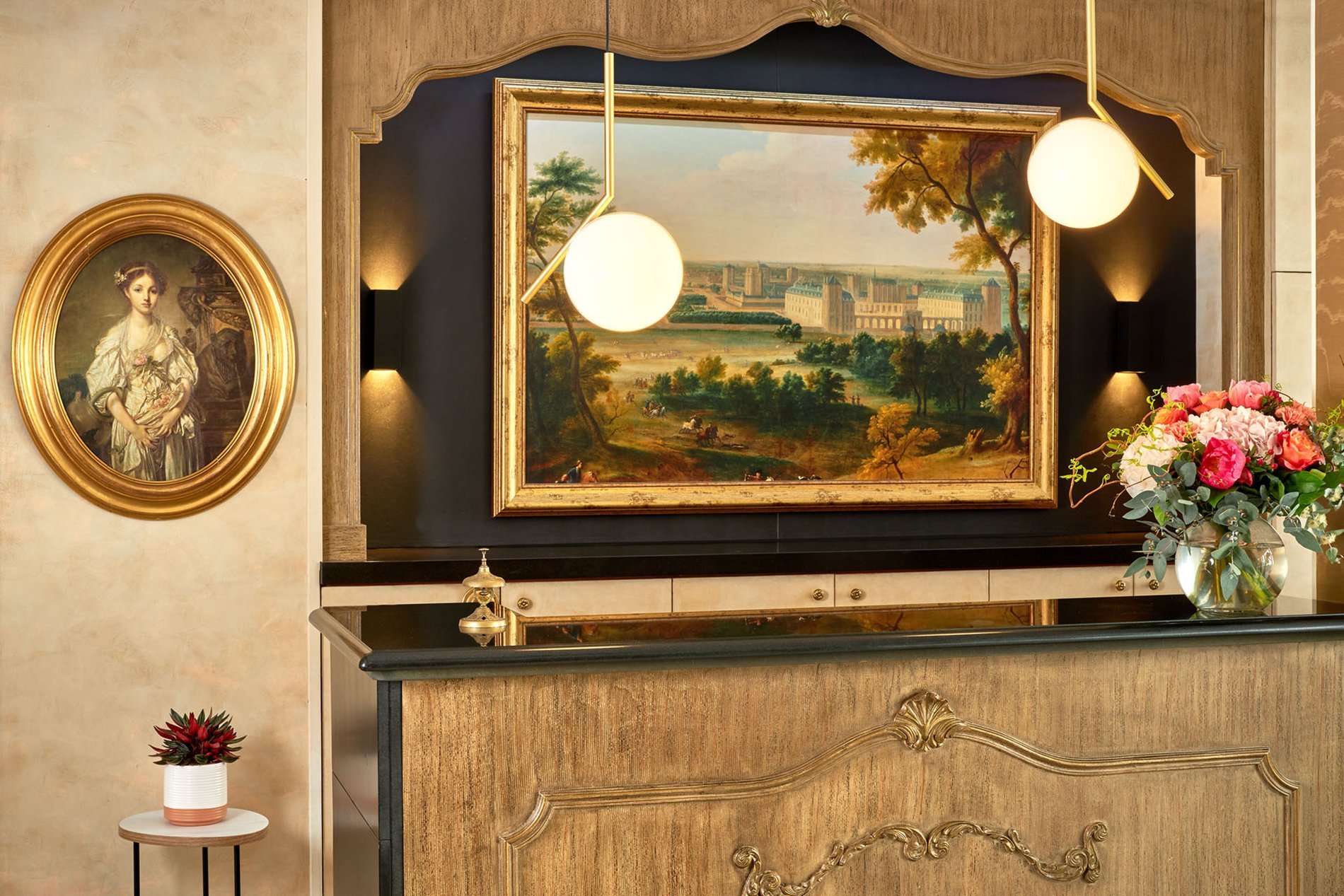 Detail of the elegant reception area of the Best Western Saint-Louis Hotel near Nogent-sur-Marne with a wooden desk and a painting.